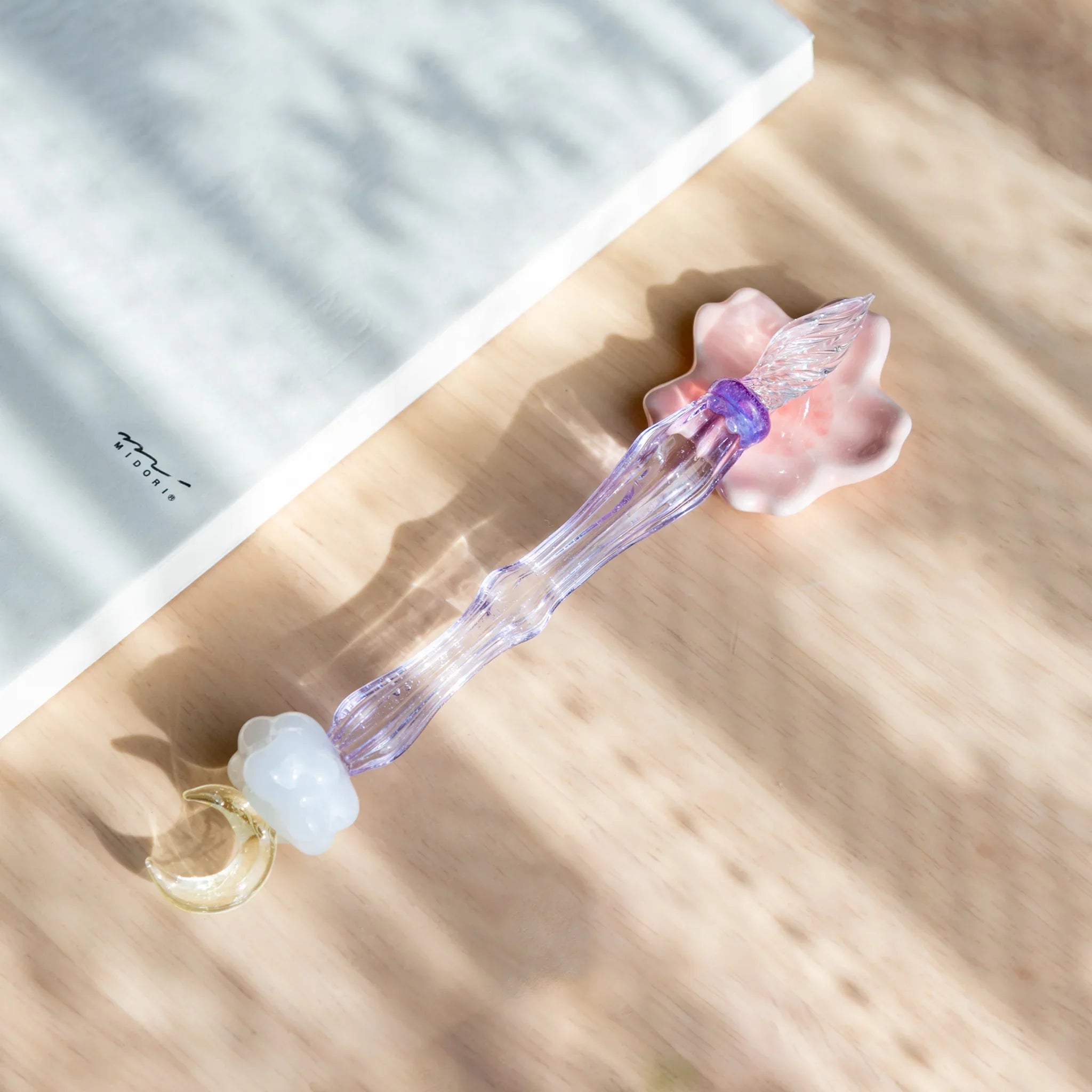 Pink sakura shaped pen rest with detailed carved flower petals showing delicate blossom form and petal vein structure detail