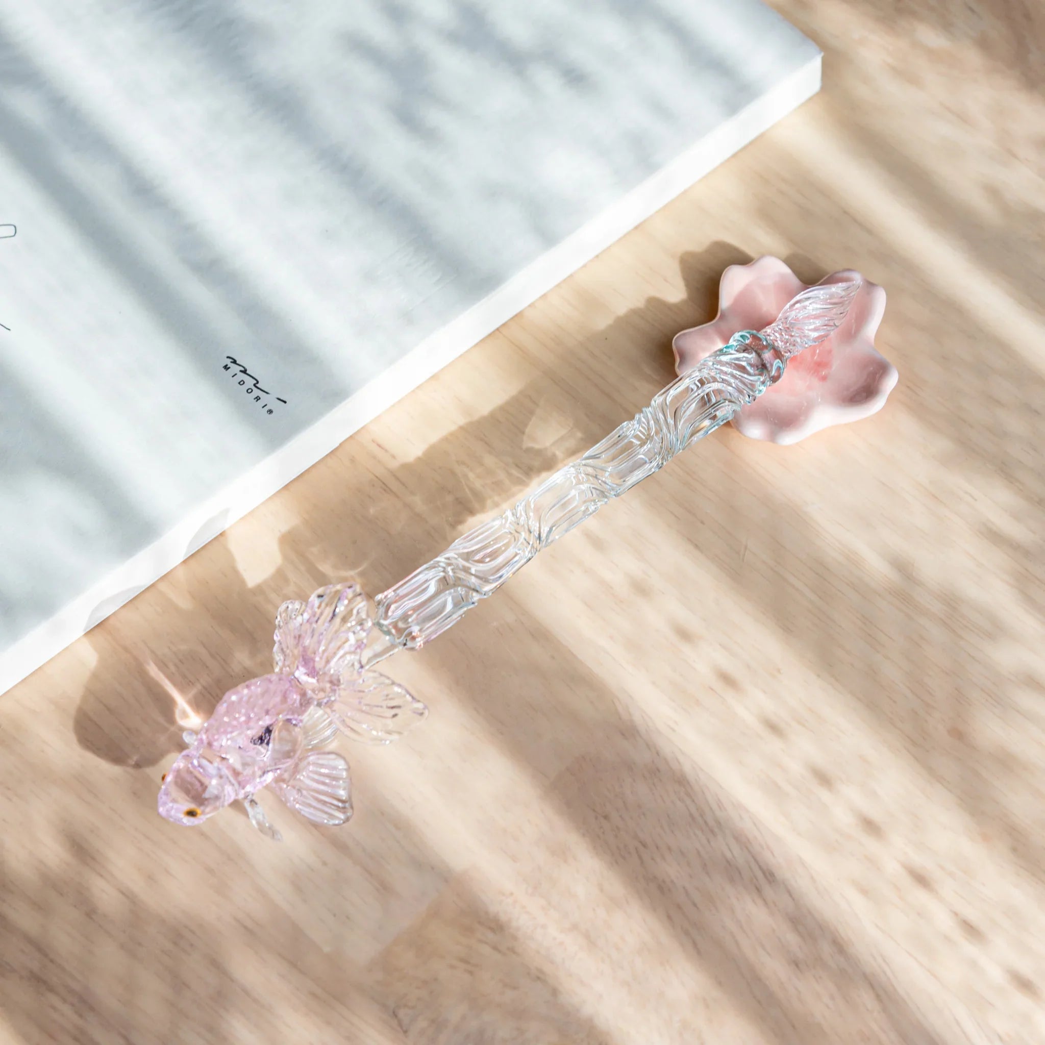 Sakura handcrafted pen rest with pale pink flower blossom design showing detailed petals and center stamen carving detail