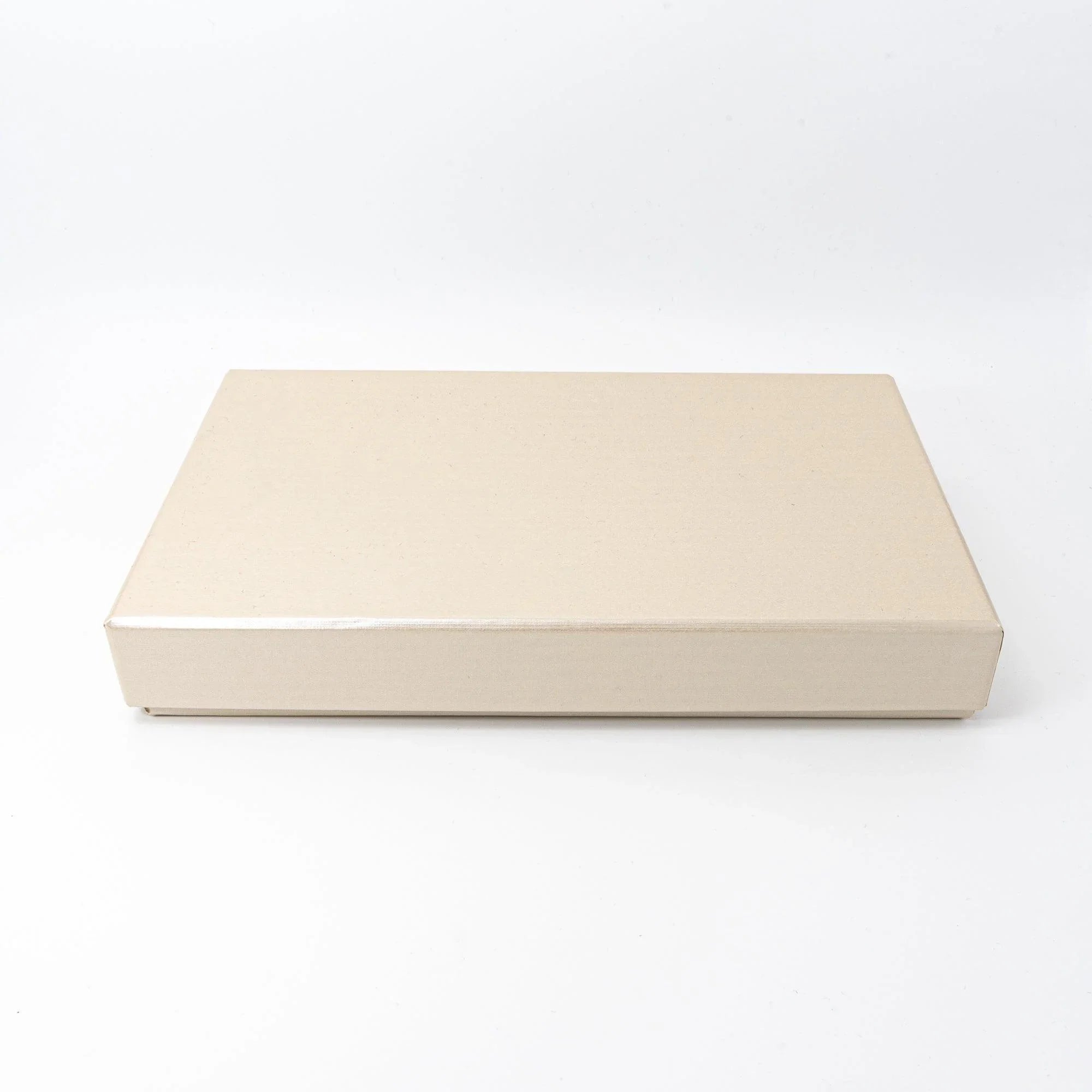Closed cream gift box for sakura shippo ware pen tray, shown closed from a side angle on white background