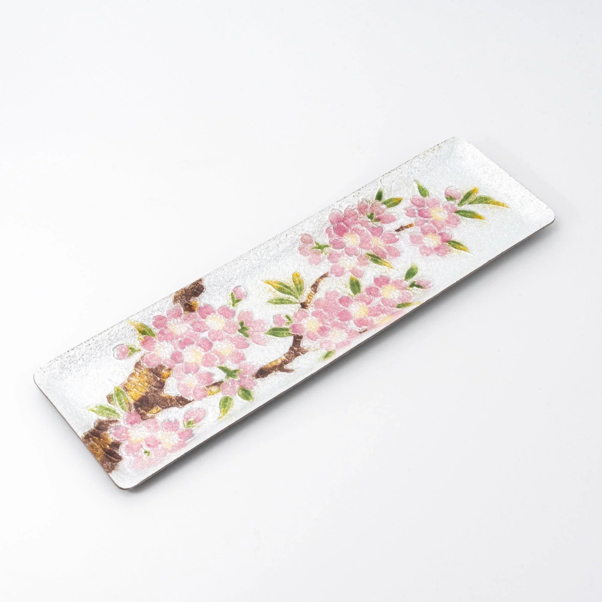 Silver enamel slim pen tray on white background, angled view showing full pink sakura and branch design from tree trunk
