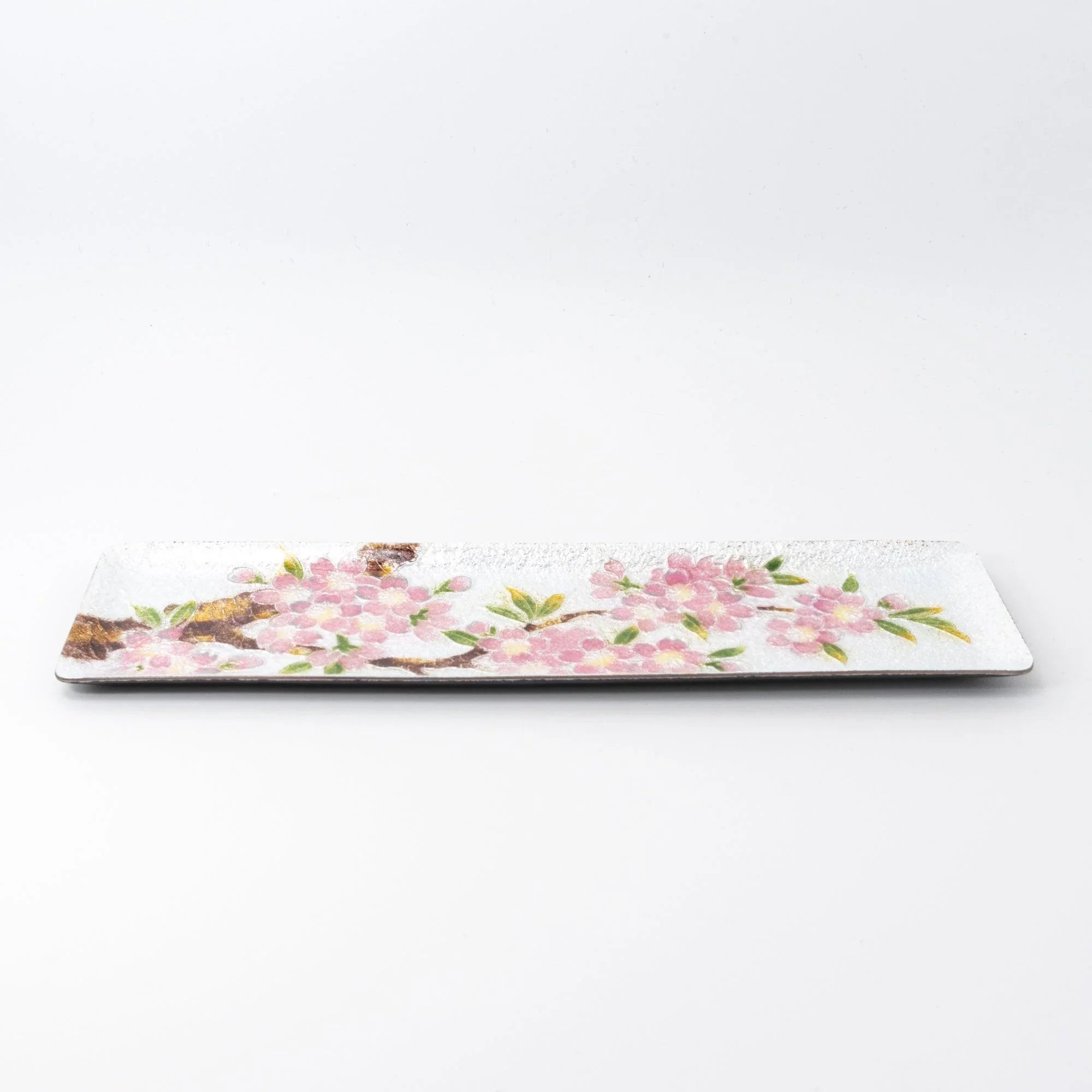 Silver enamel slim pen tray on white background, side view showing full width with pink sakura blossom design from tree trunk