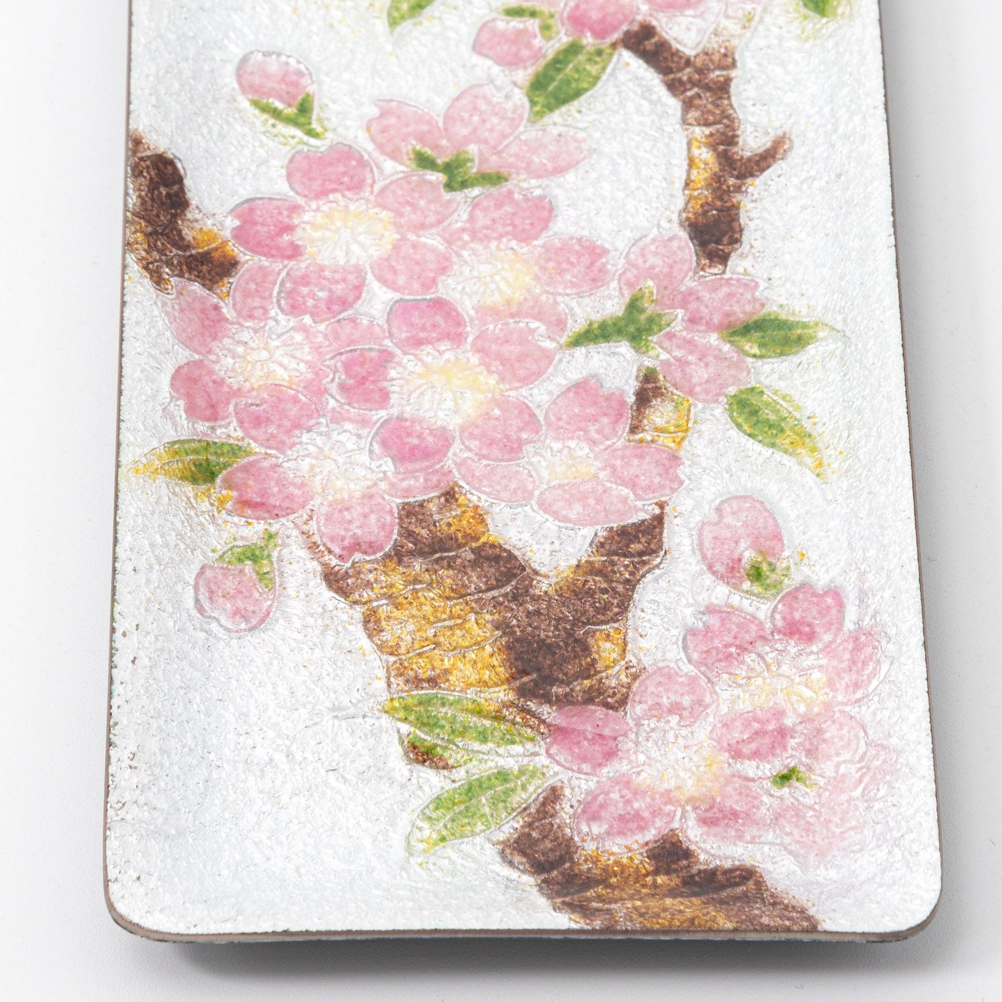 Close-up of silver enamel tray showing cherry tree trunk with gold accents and dense pink sakura blossom clusters