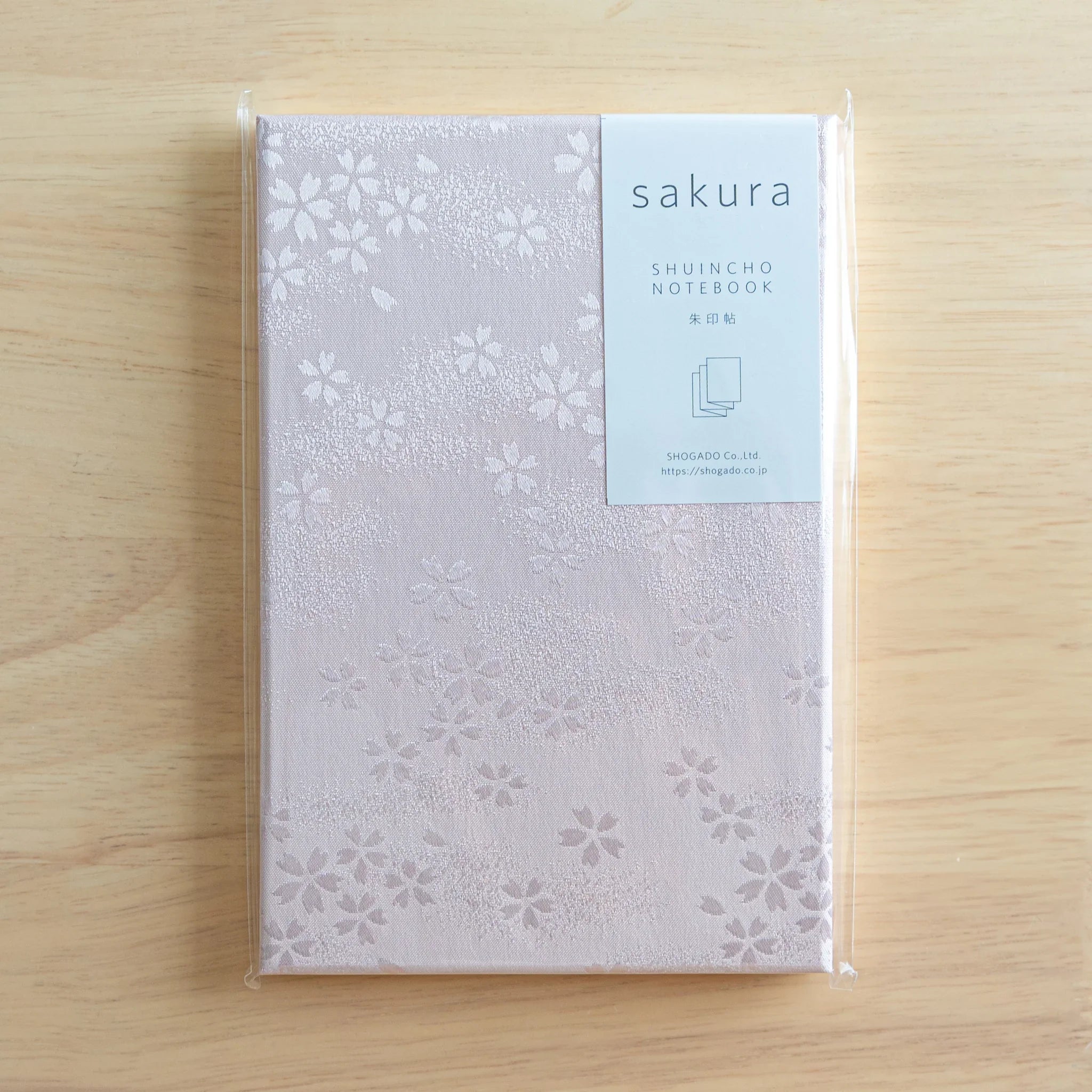 Sakura washi goshuincho in original packaging with Shuincho Notebook label by Shogado on light wood surface