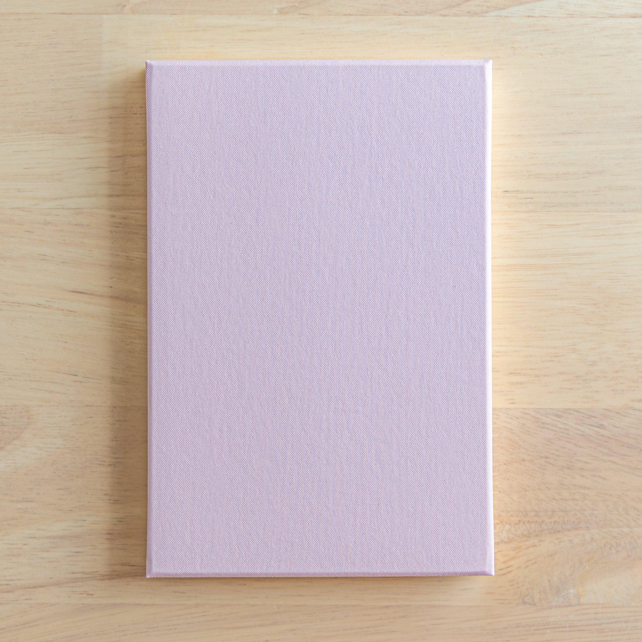 Sakura washi goshuincho back cover showing solid light lavender textured fabric surface on light wood