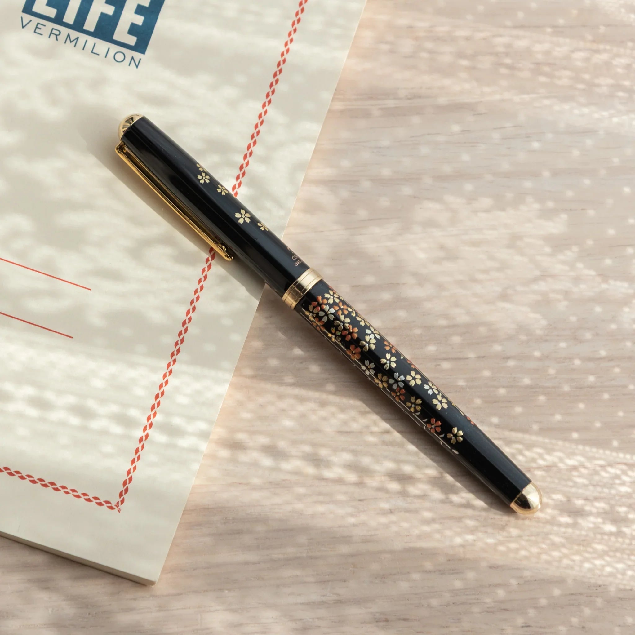 Sakura Yamanaka ballpoint pen displays hand-painted lacquer cherry blossom and branch artwork detail