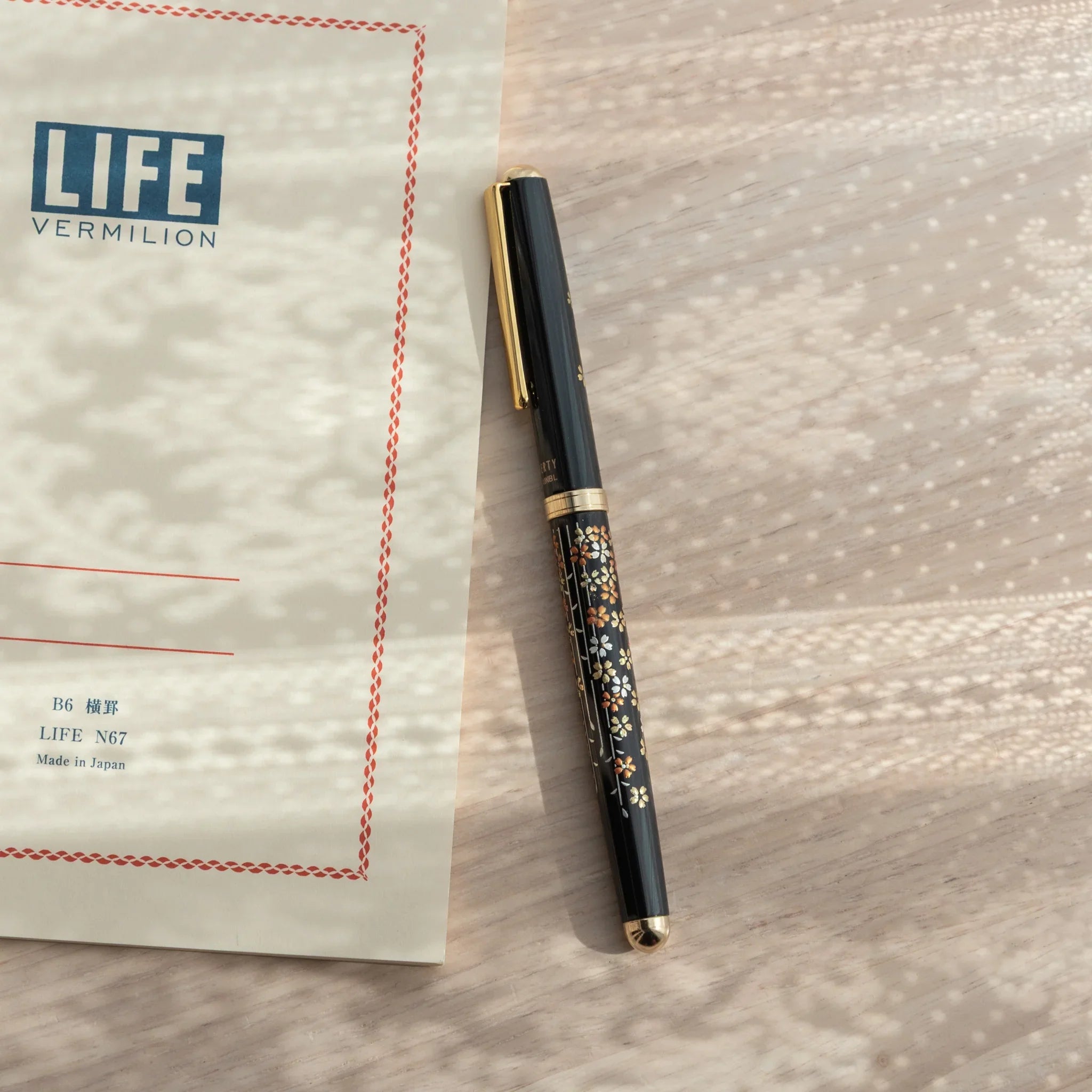 Yamanaka lacquer ballpoint pen displays hand-painted sakura in soft pink and white lacquer finish hand-made