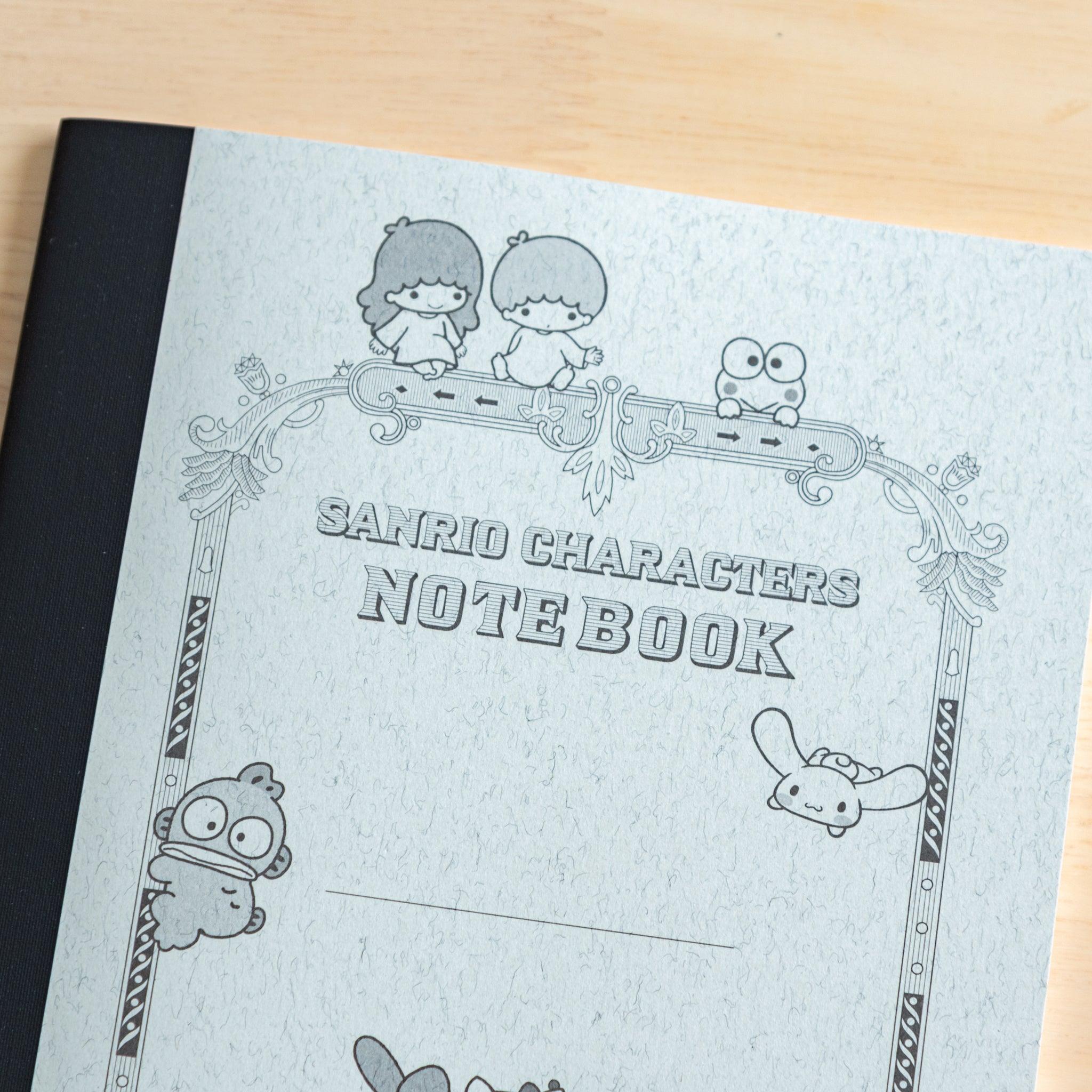 A close-up of a Japanese stationery notebook cover with Sanrio characters, including Hello Kitty and My Melody, drawn in a vintage-style decorative frame.