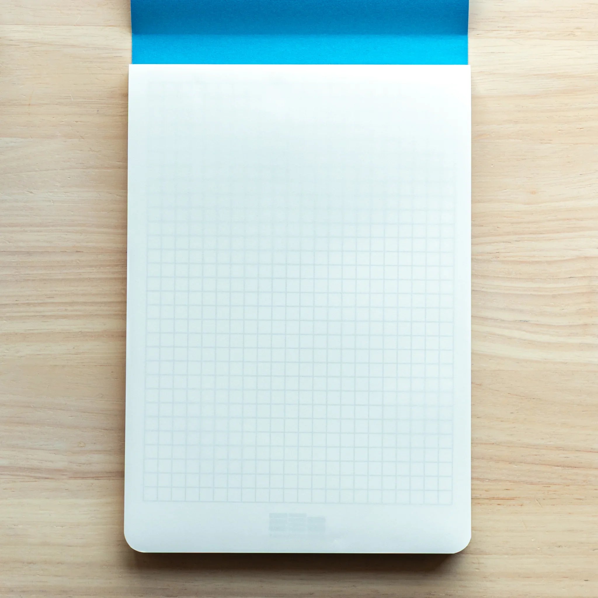 Sanzen Tomoe River A5 Japanese Writing Pad shown with grid guide sheet for structured and organized writing.