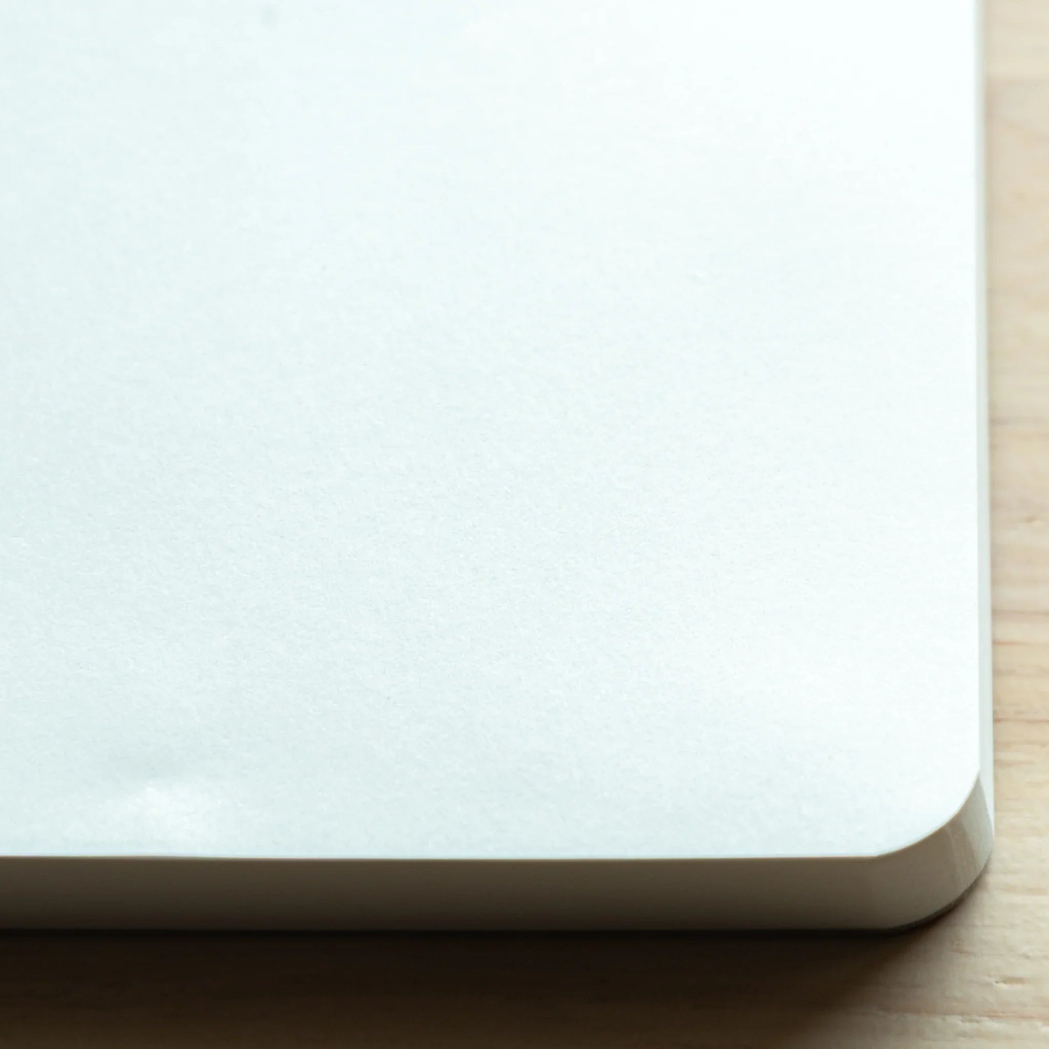 Corner close-up of Sanzen Tomoe River Japanese Writing Pad A5, high-quality plain sheets for pen lovers.