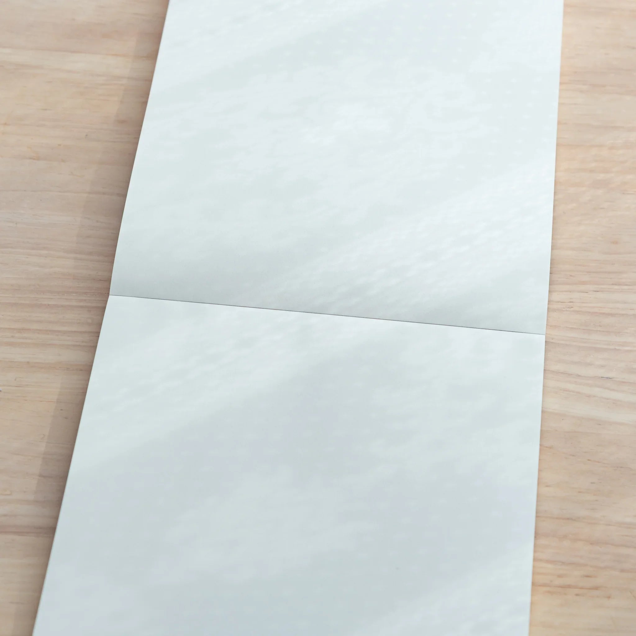 Open spread of Sanzen Tomoe River A5 Japanese Writing Pad, featuring plain smooth sheets for writing enjoyment.