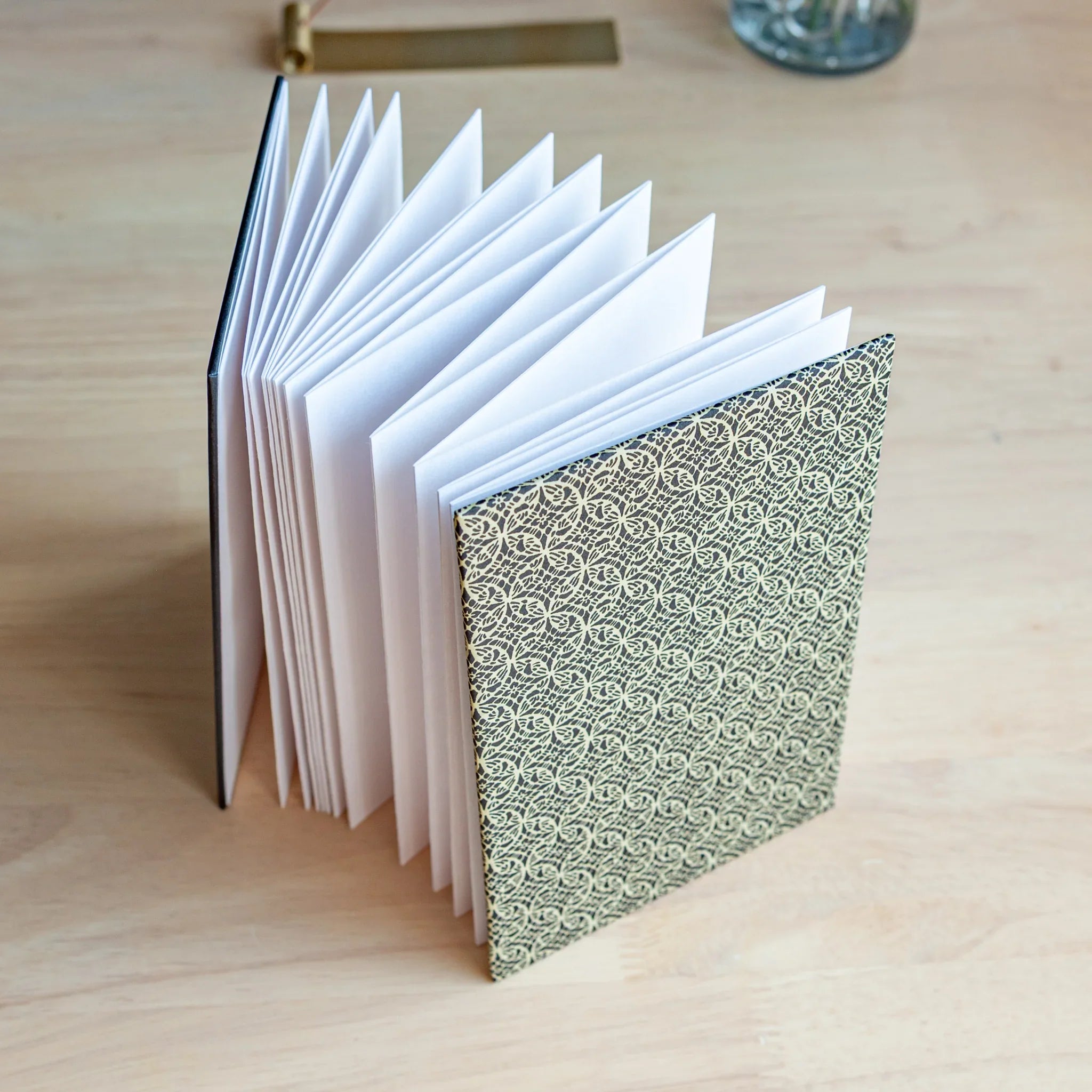 Shippo Pattern washi goshuincho stamp book standing upright with accordion fold pages visible and dark navy shippo cover