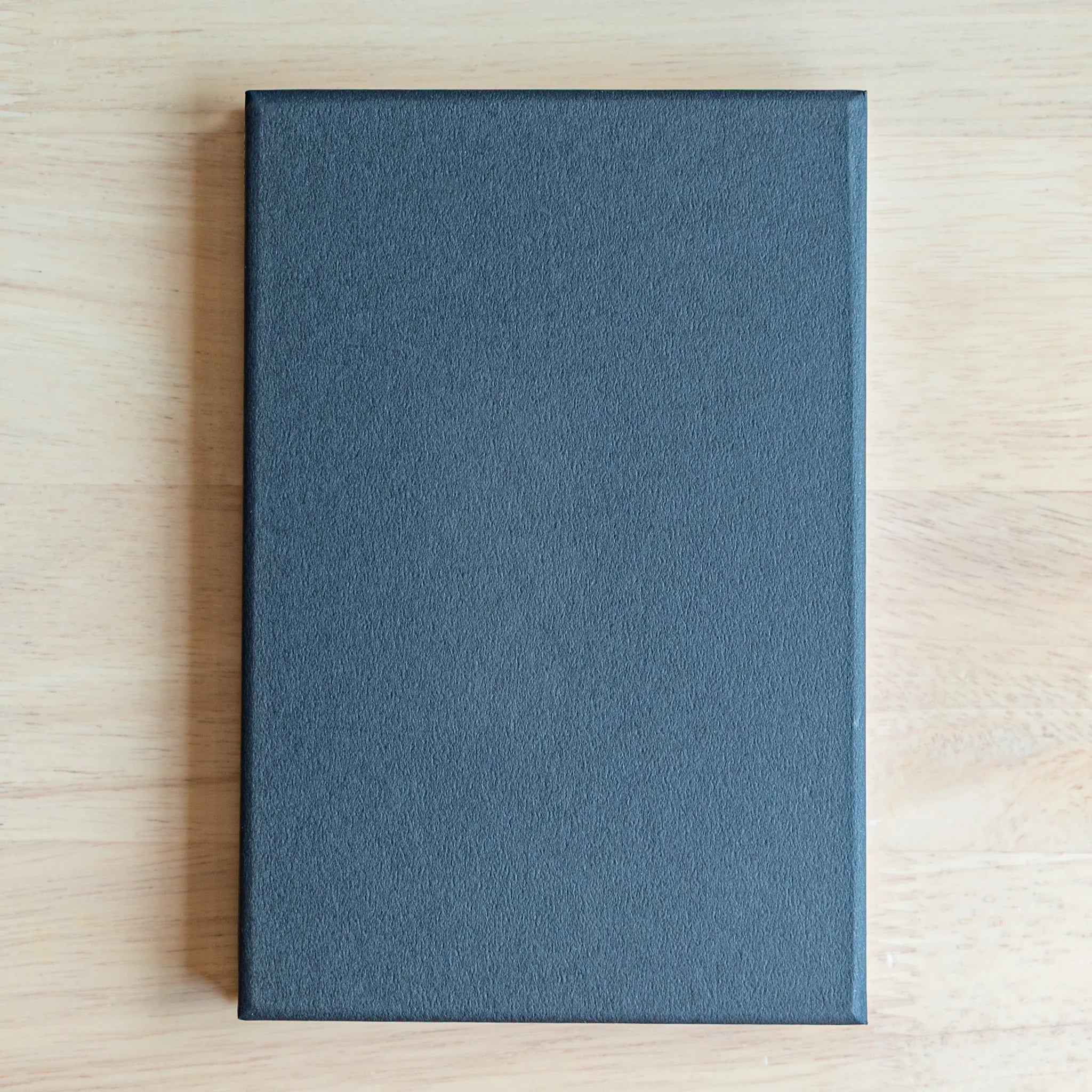 Shippo Pattern washi goshuincho back cover showing solid dark navy textured fabric surface on light wood