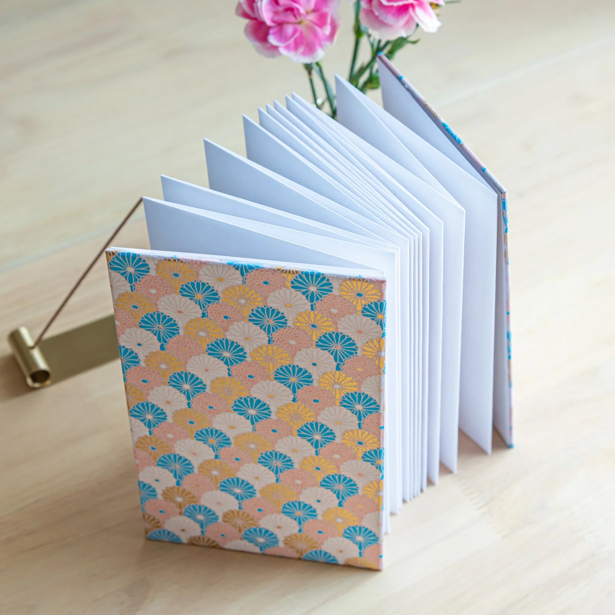 Sky Blossom Goshuincho accordion fold stamp book opened displaying pastel sky-blue pages with chrysanthemum pattern