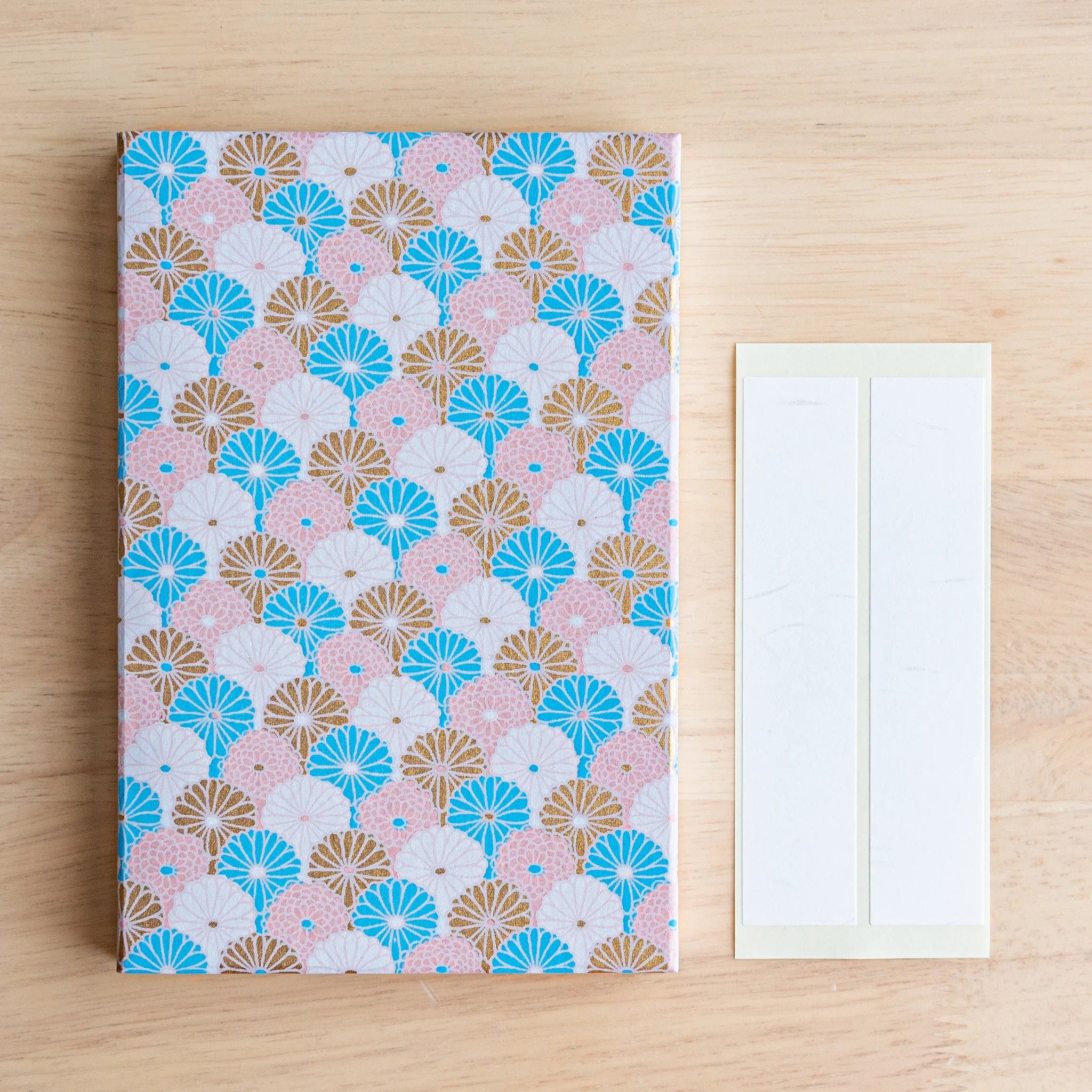 Sky Blossom Goshuincho open book display showing interior accordion folds and chrysanthemum pattern on sky-blue