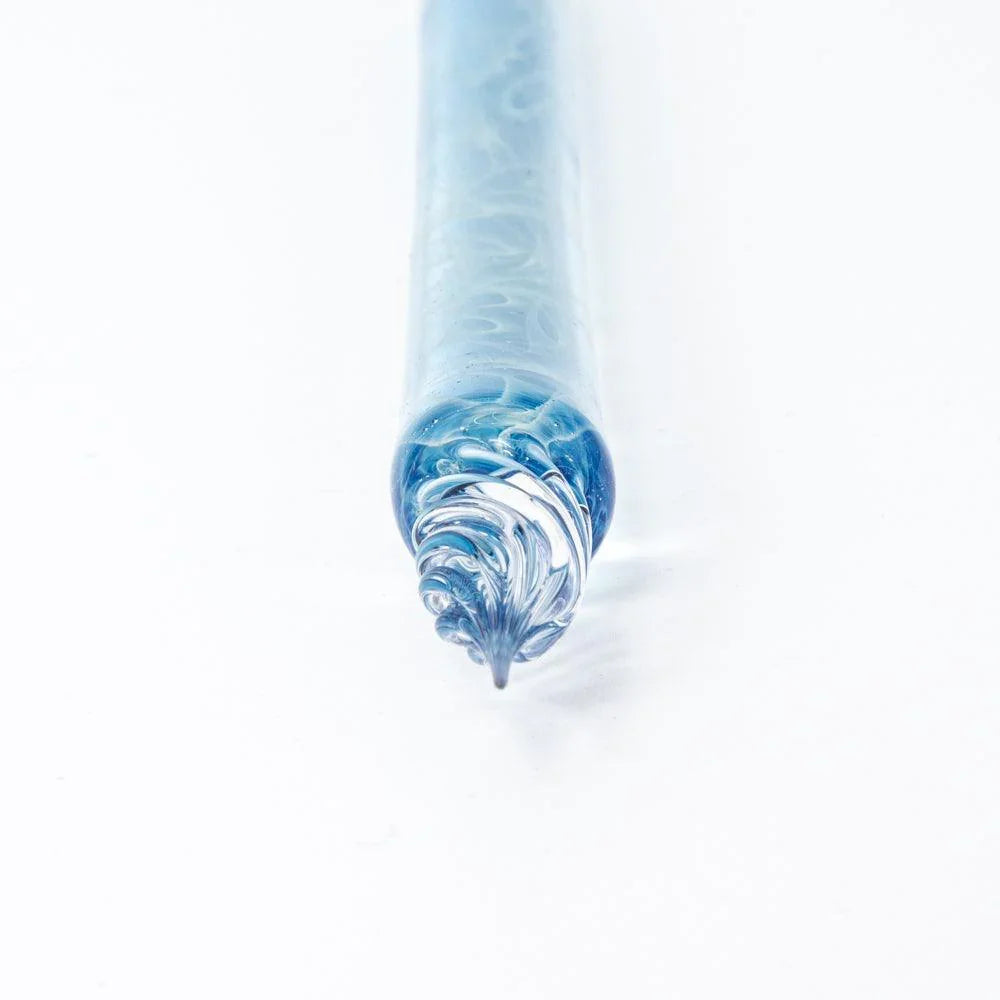 Smoke in Azure glass dip pen macro shot of silver nib tip with blue glass viewed from below angle view