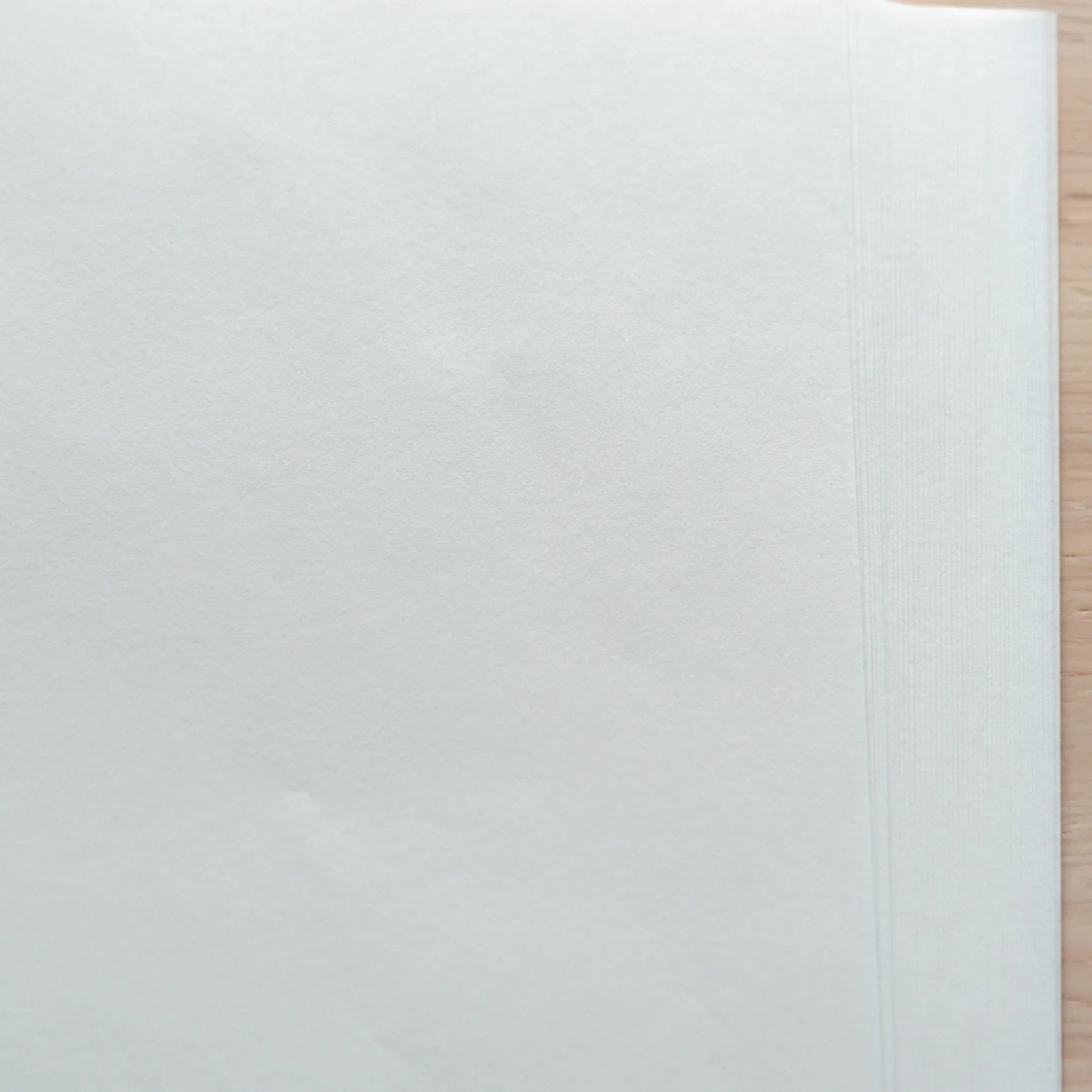 Stack of smooth onion skin loose leaf papers in A4 size, alcohol ink compatible, shown on a wooden surface.