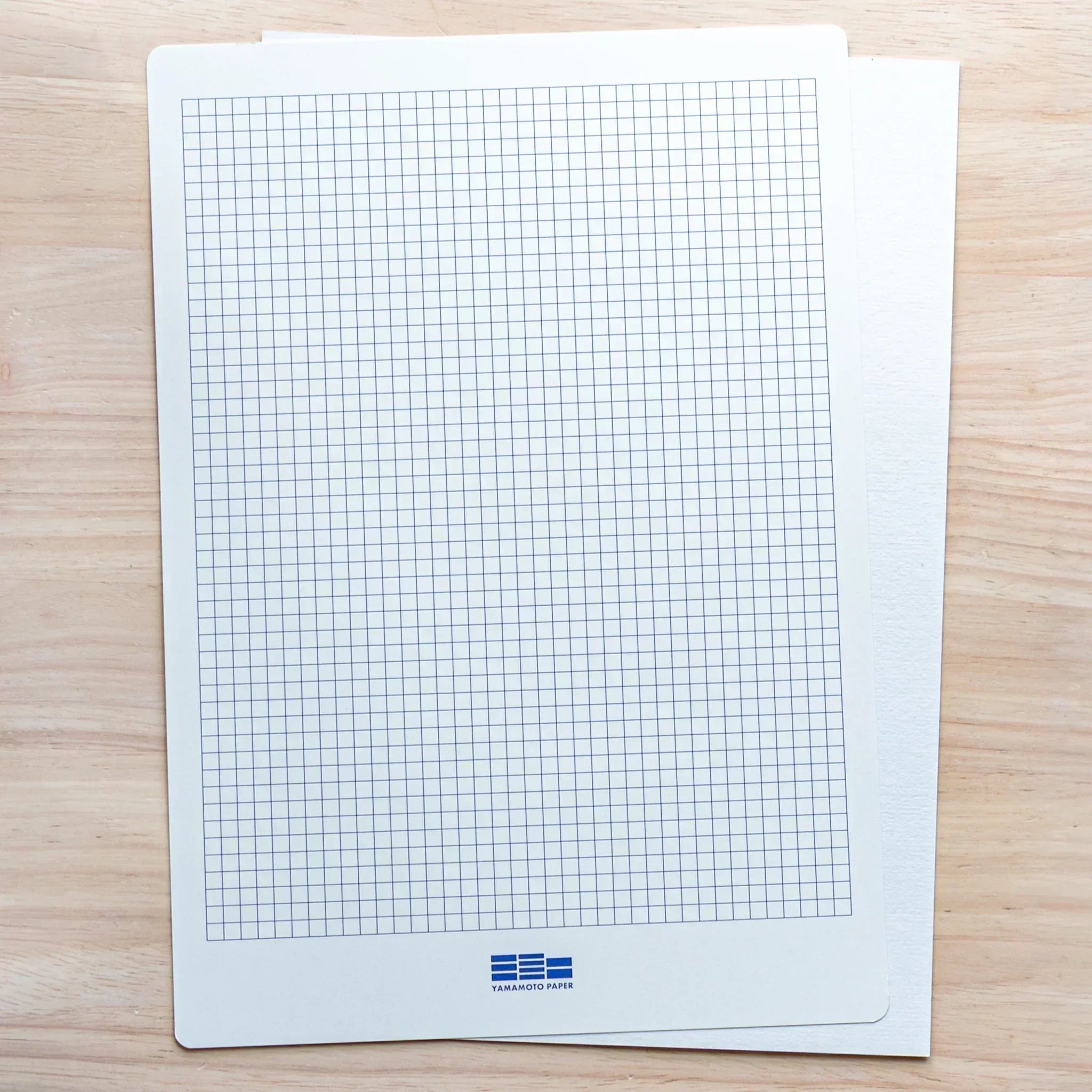 Blue ruled writing underlay sheet designed to guide handwriting on loose leaf paper.