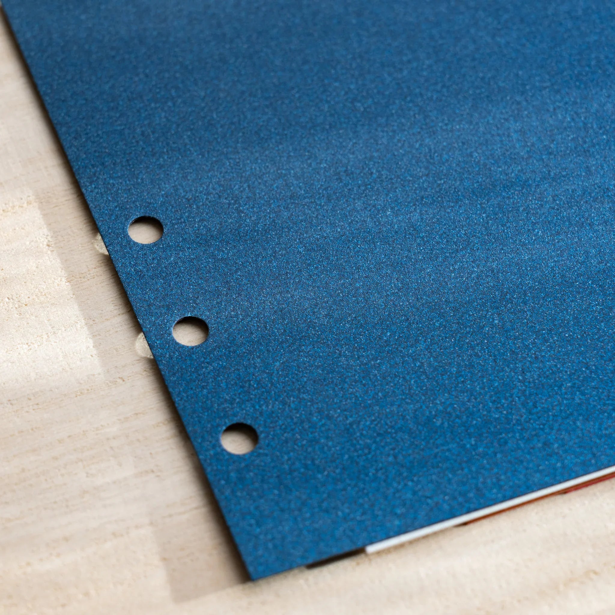 Japanese Stationery Stardream index divider for Bible size planners, close-up of blue page with punched holes.