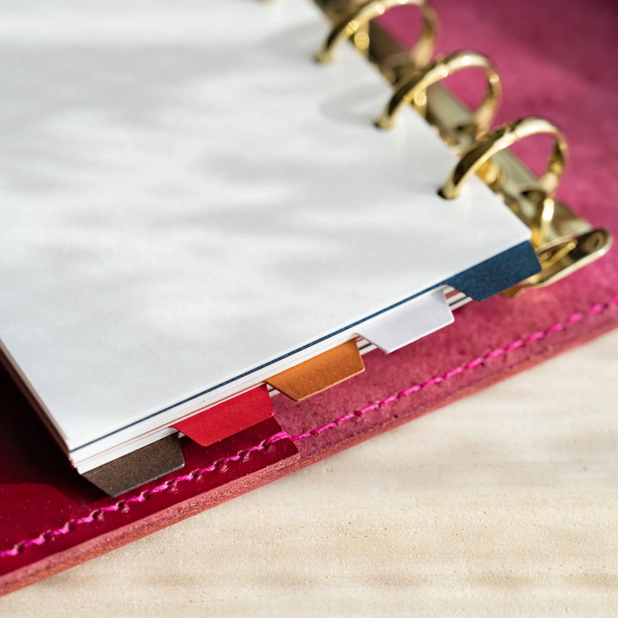 Japanese Stationery Stardream index dividers for Mini 6 planners with colorful tabs in a gold-ringed planner.