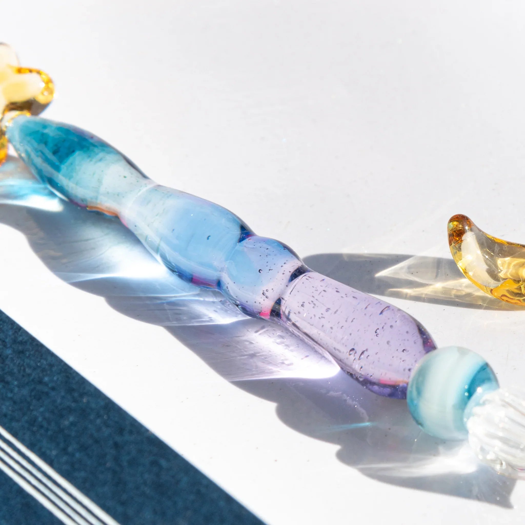 Starlit Night glass dip pen in deep blue tone with teal wrapped handle section and gold star pen rest detail shine