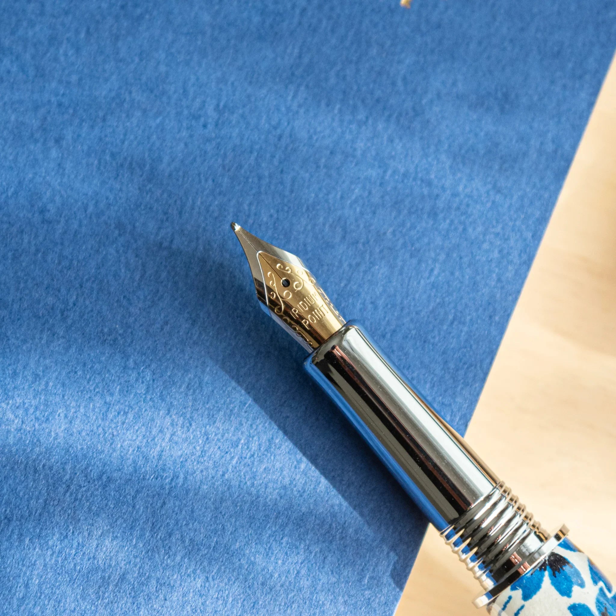 Streaming Sakura Mino Washi fountain pen displaying navy background with swirling cherry blossom pattern and water-flow motif