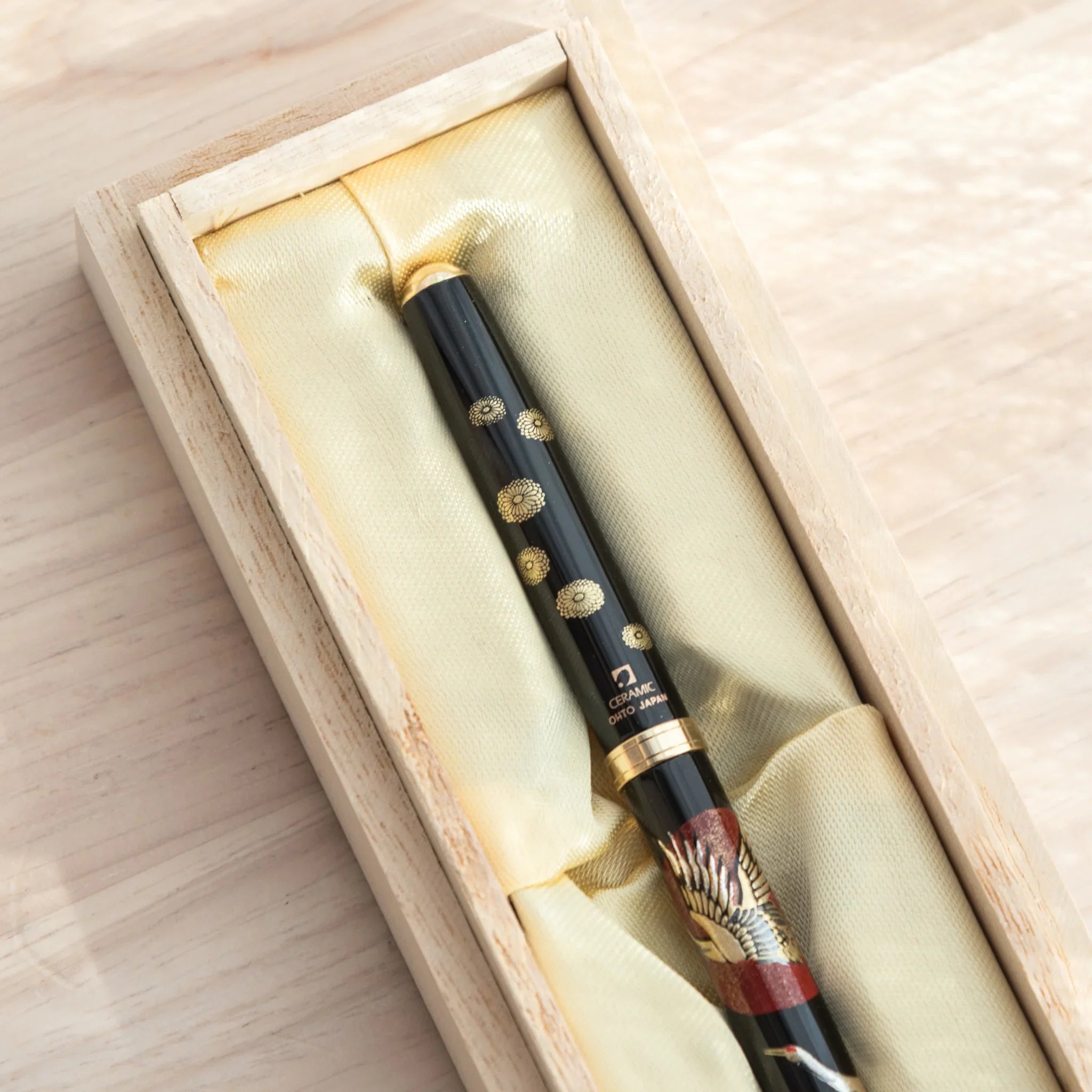 Close-up of a Japanese Ballpoint Pen featuring Lacquer artwork of cranes and red sun.