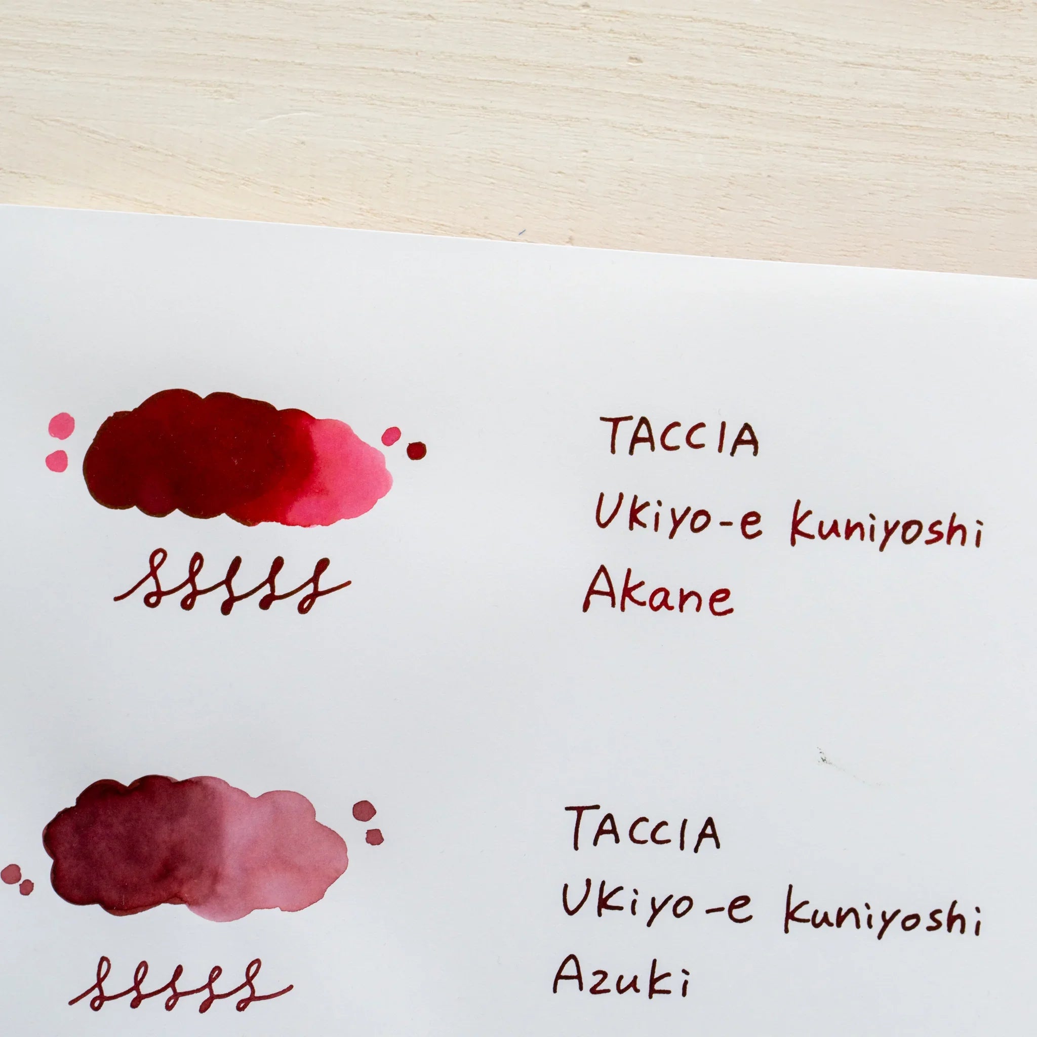 TACCIA Ukiyo-e Kuniyoshi Akane hand-painted swatch shown with neighboring ink colors on YU-SARI notebook.