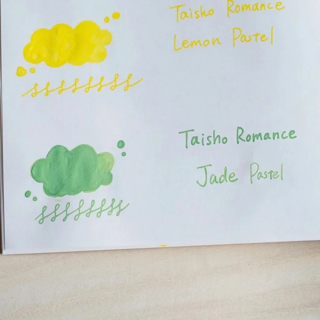 Handwritten swatch of Taisho Romance Jade Pastel ink, a cloud-shaped wash and a looped line in grass green