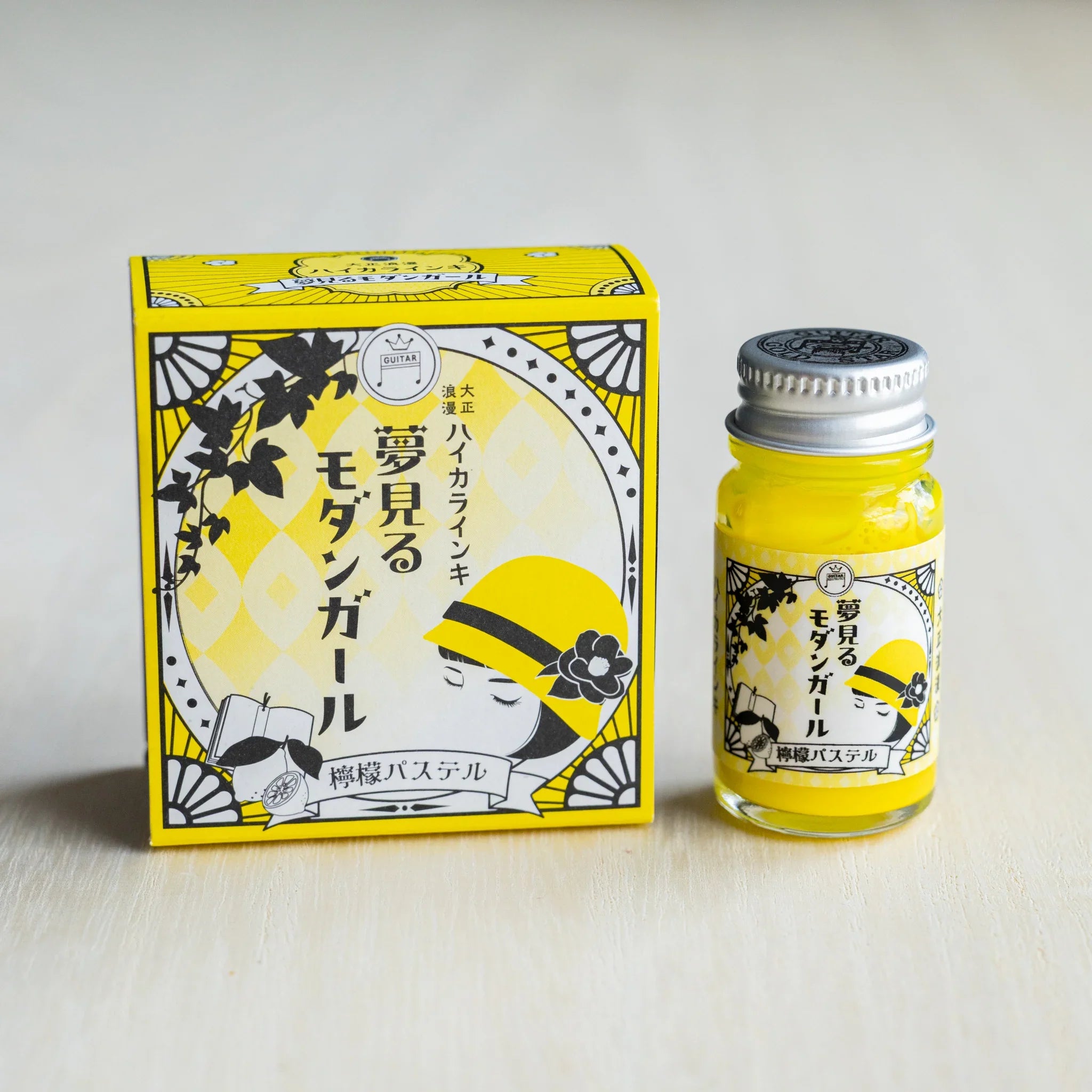 Taisho Romance Lemon Pastel ink box in bright yellow beside a 12 ml glass bottle of opaque yellow pigment ink