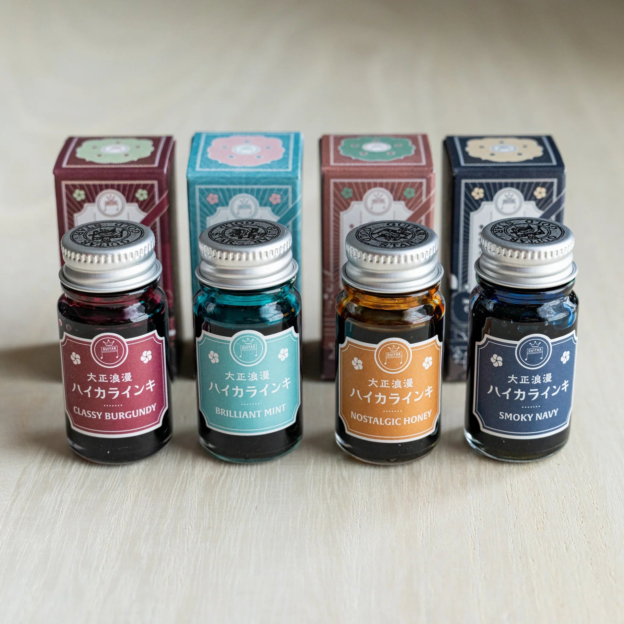 Taisho Romance HAIKARA Romanticism ink set, four 12 ml bottles standing in front of their illustrated boxes