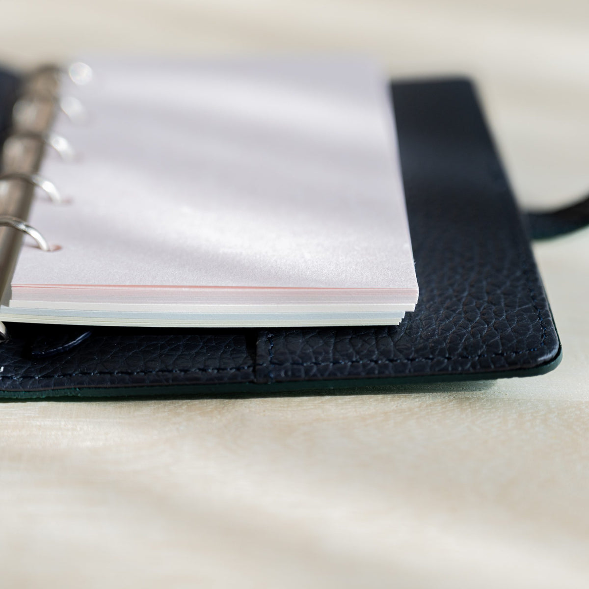 Stack of Feather Waltz M5 refills on planner rings showing layered pastel edges