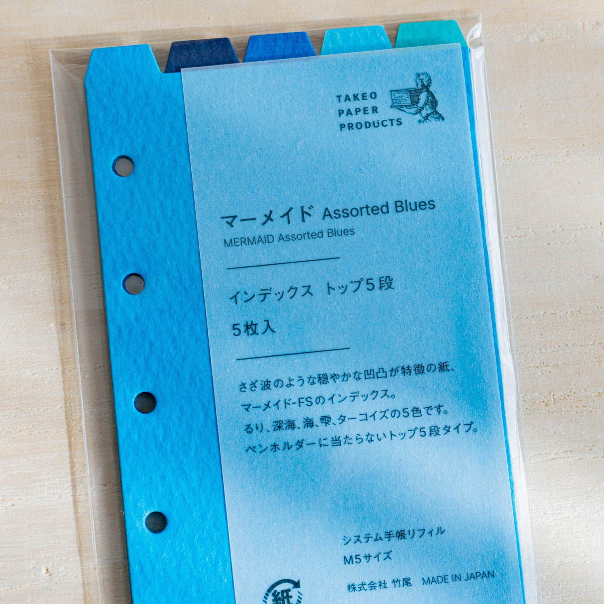 Close-up of the Mermaid Assorted Blues M5 package label in Japanese with TAKEO PAPER PRODUCTS logo