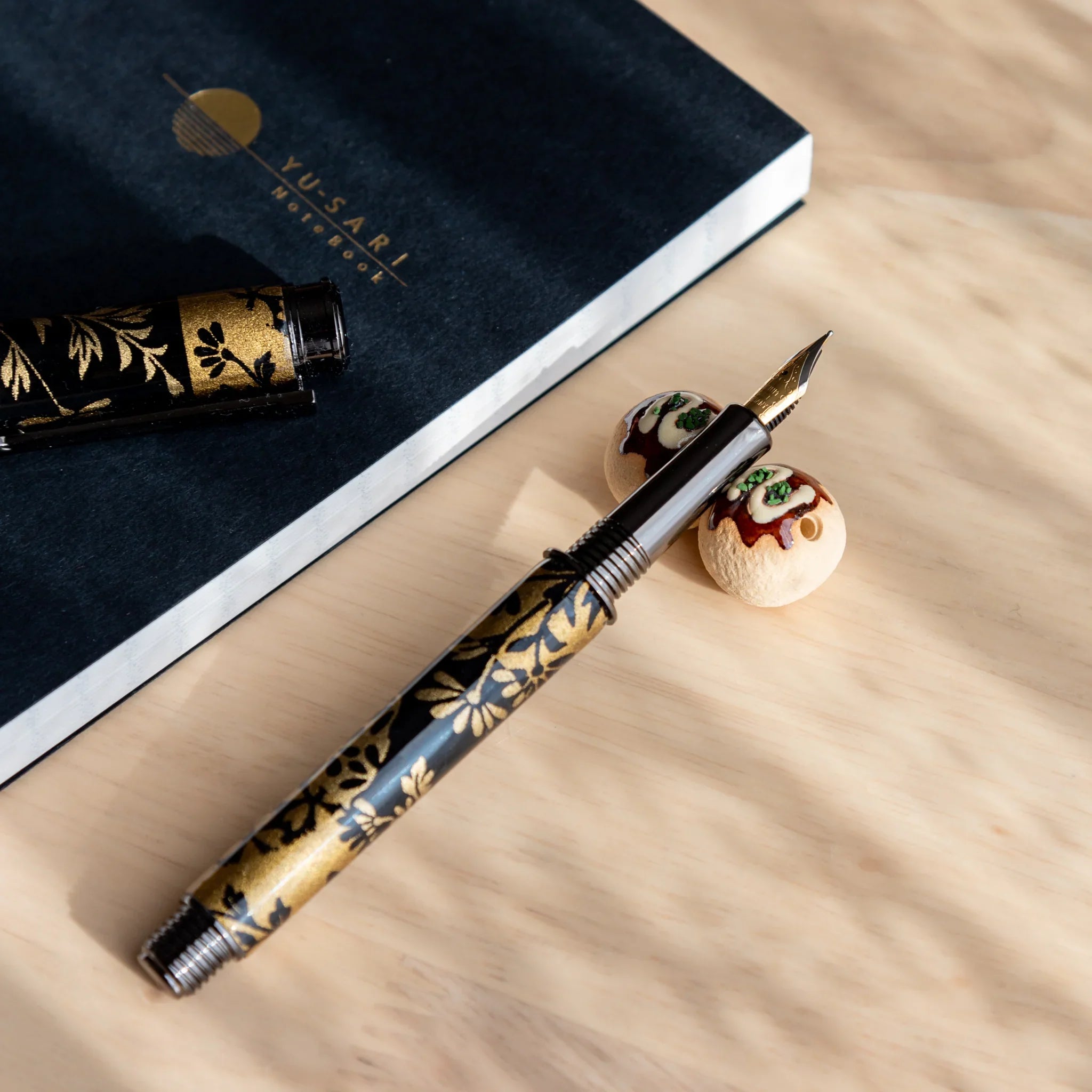Takoyaki ceramic pen rest handcrafted golden brown Japanese octopus ball with shiny glazed finish detail close shot