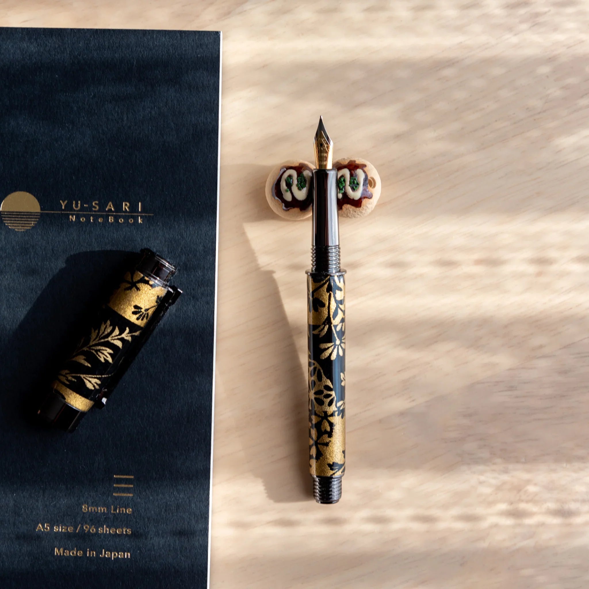 Takoyaki octopus ball ceramic pen rest Japanese handcrafted brown with distinctive spherical form shape close shot