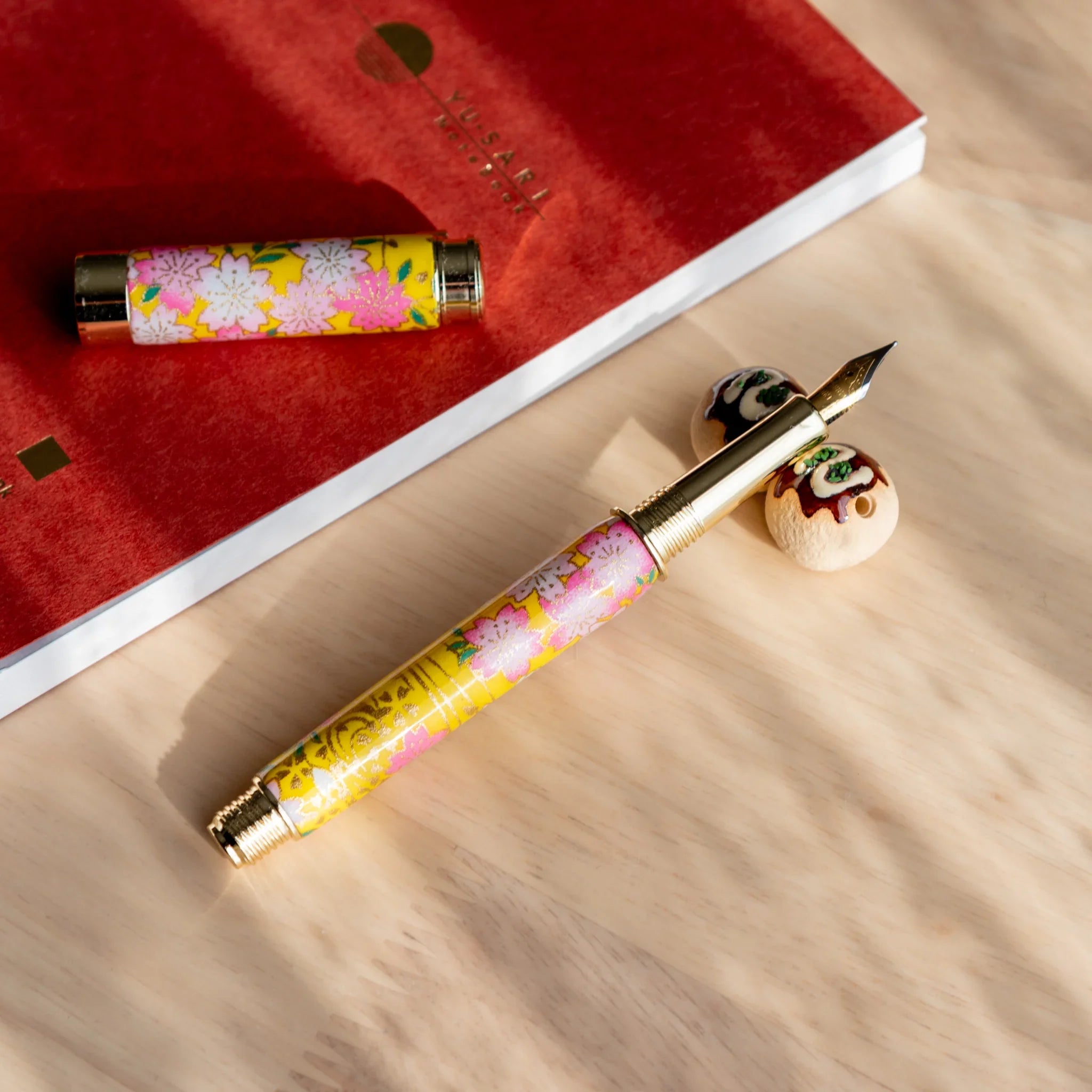 Brown takoyaki ceramic pen rest handcrafted Japanese with realistic octopus ball shaped design detail close shot