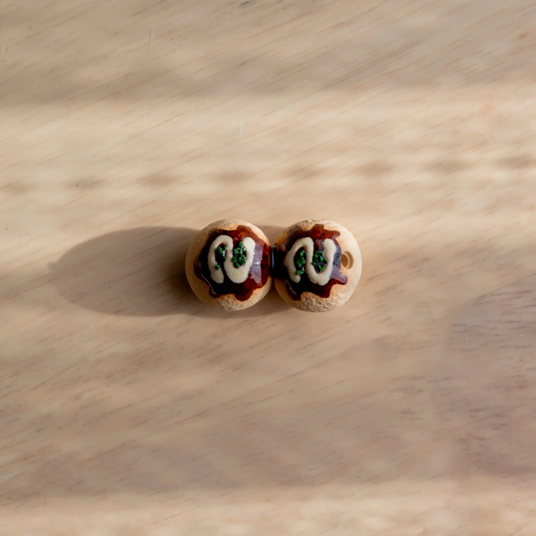 Takoyaki ceramic pen rest golden brown handcrafted Japanese with authentic ball shape and glazed finish close shot