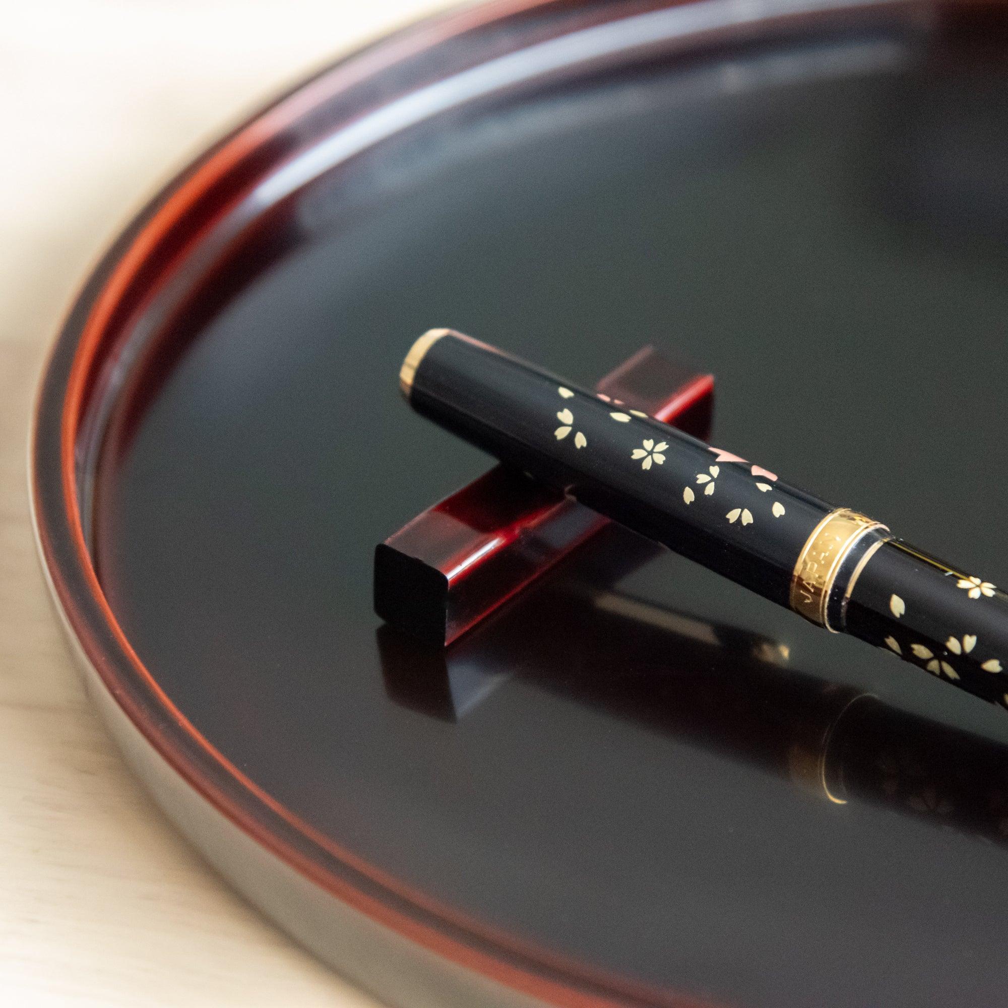 Tame-Nuri black Echizen lacquered sakura wood pen rest features aged hand-rubbed finish, keeping pens secure during work