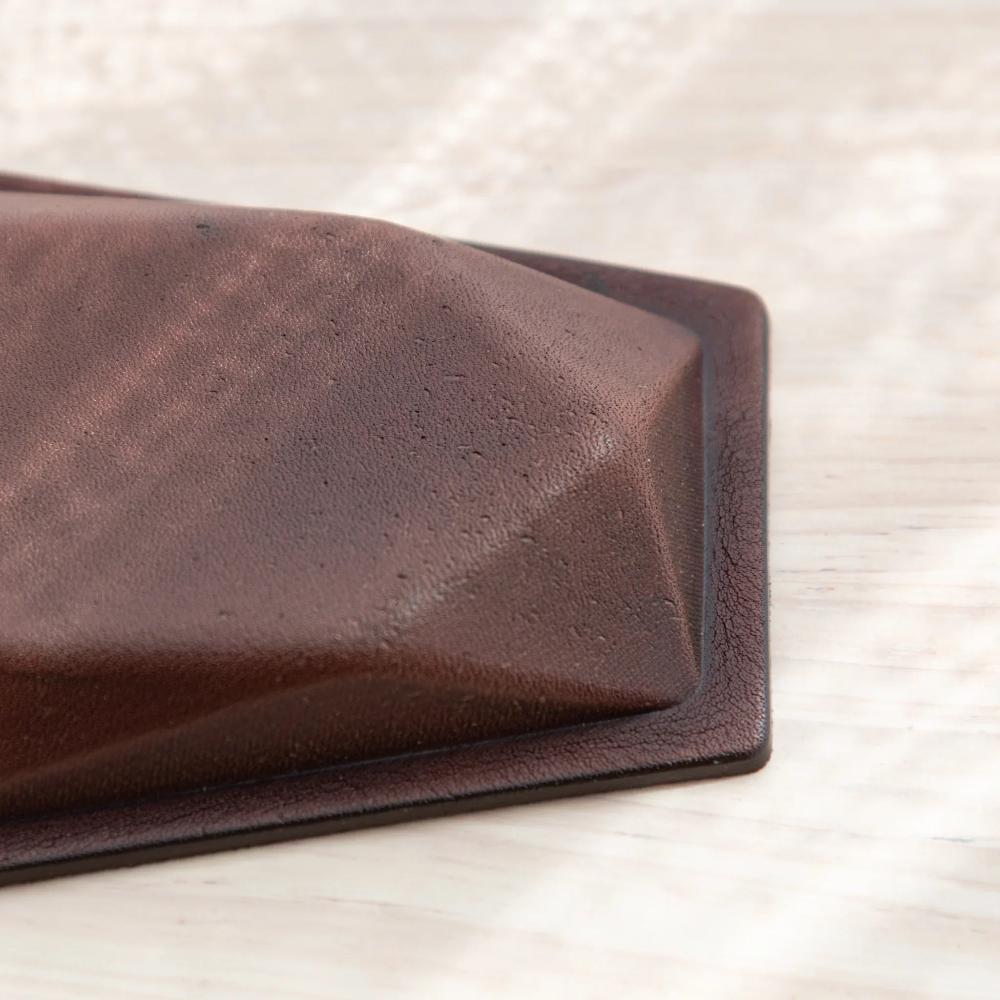 Detail of the leather base of the Japanese Pen Tray with elegant contours and texture.