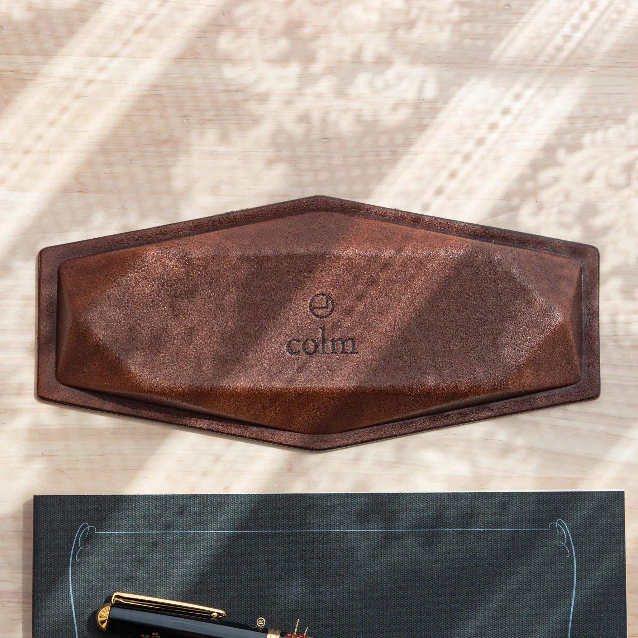 Top-down view of Japanese Pen Tray’s leather bottom, featuring colm logo embossing.