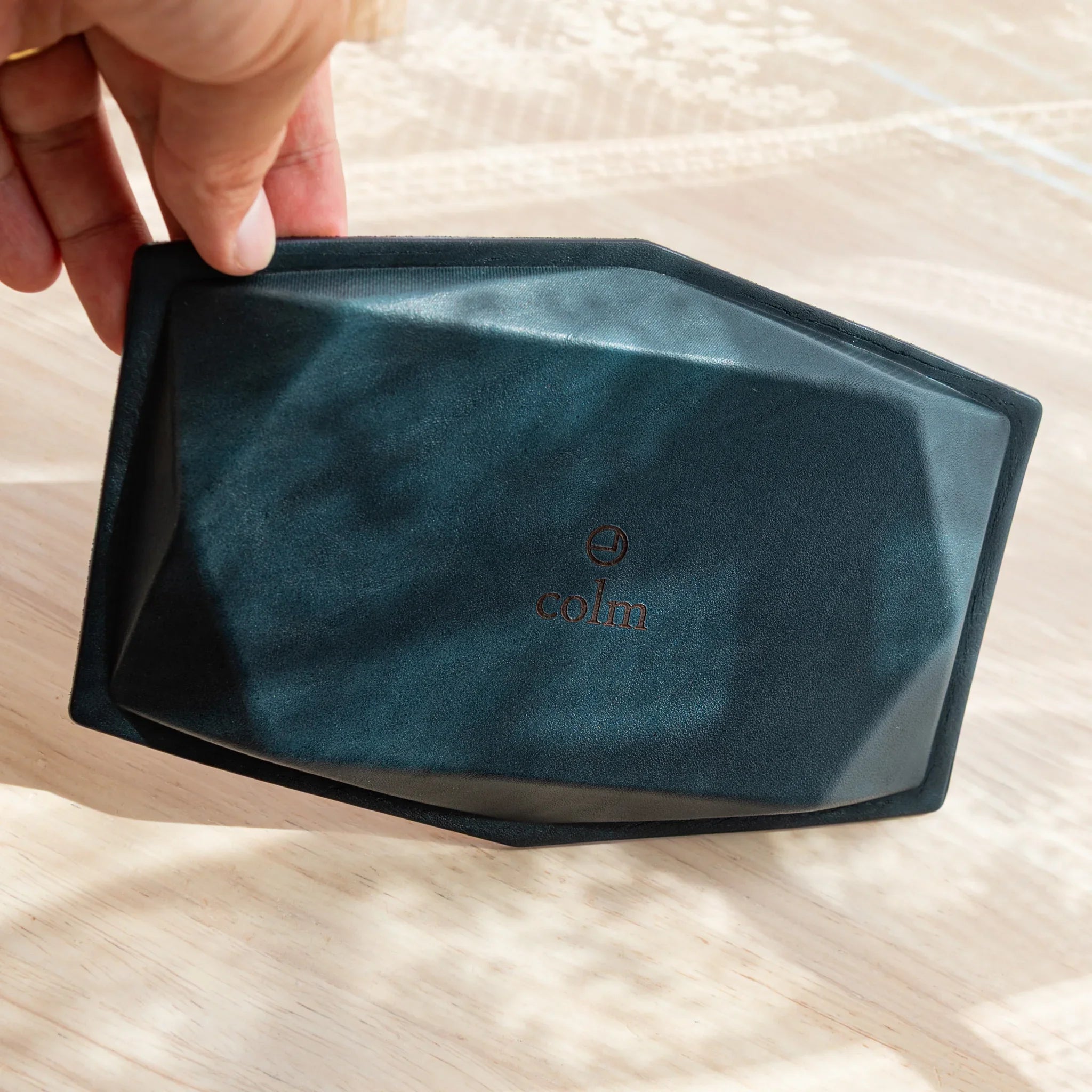 Back side of the Japanese Pen Tray showing the “colm” logo and leather surface.