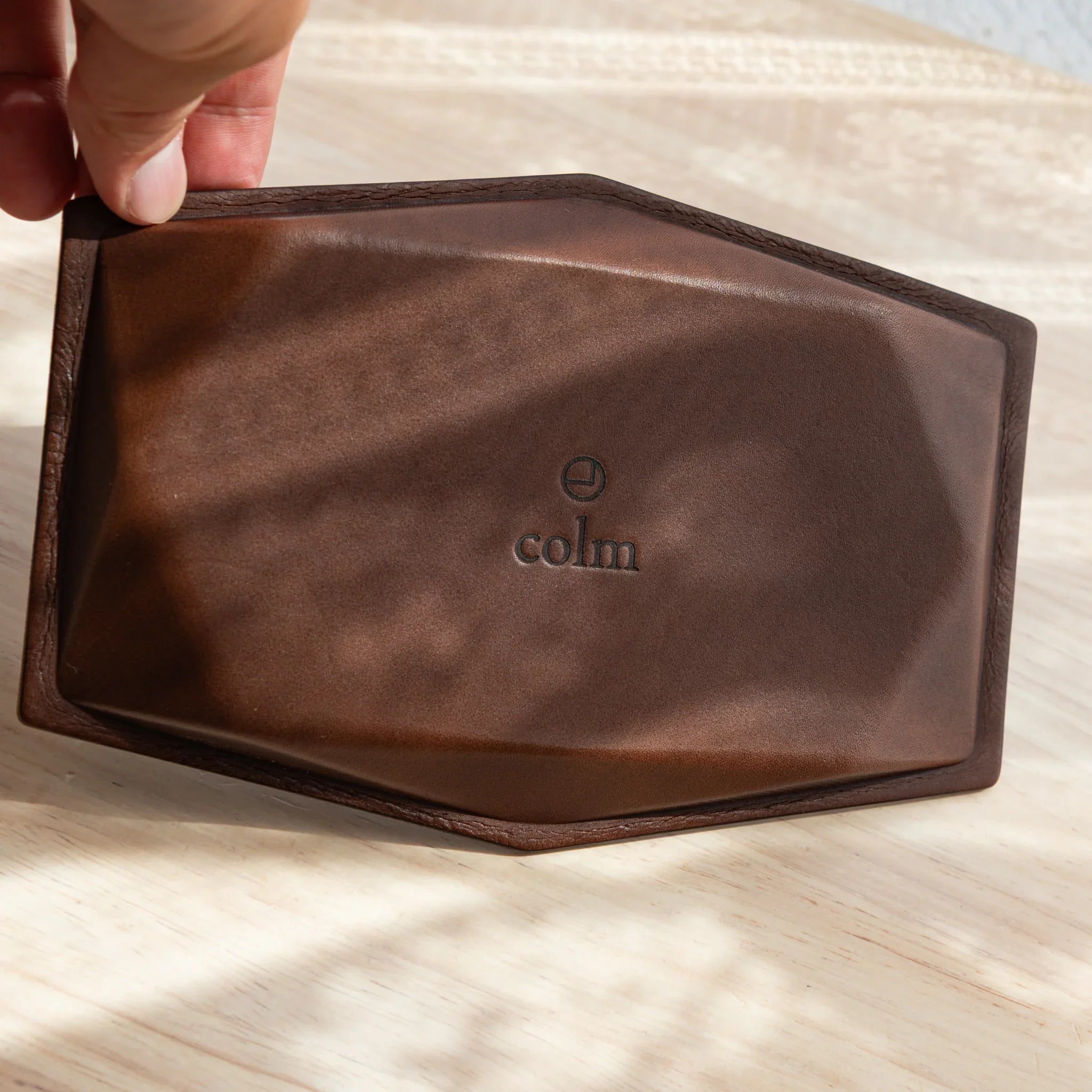 Back side of Japanese Pen Tray made of brown leather with colm logo.