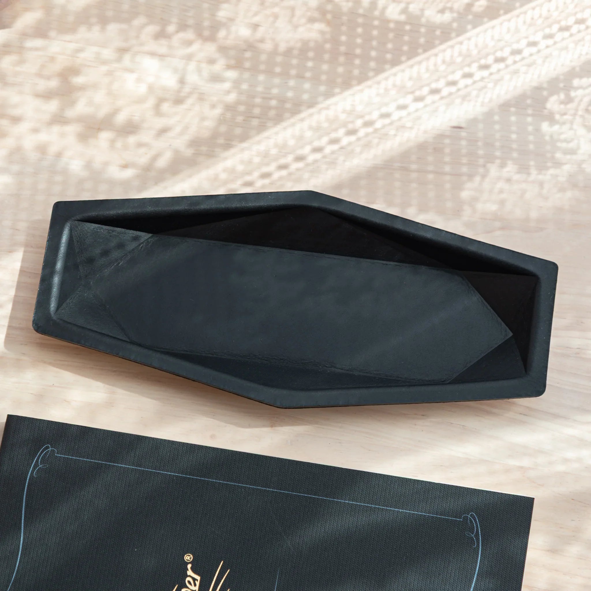 Minimalist Japanese Pen Tray in black leather, empty interior.