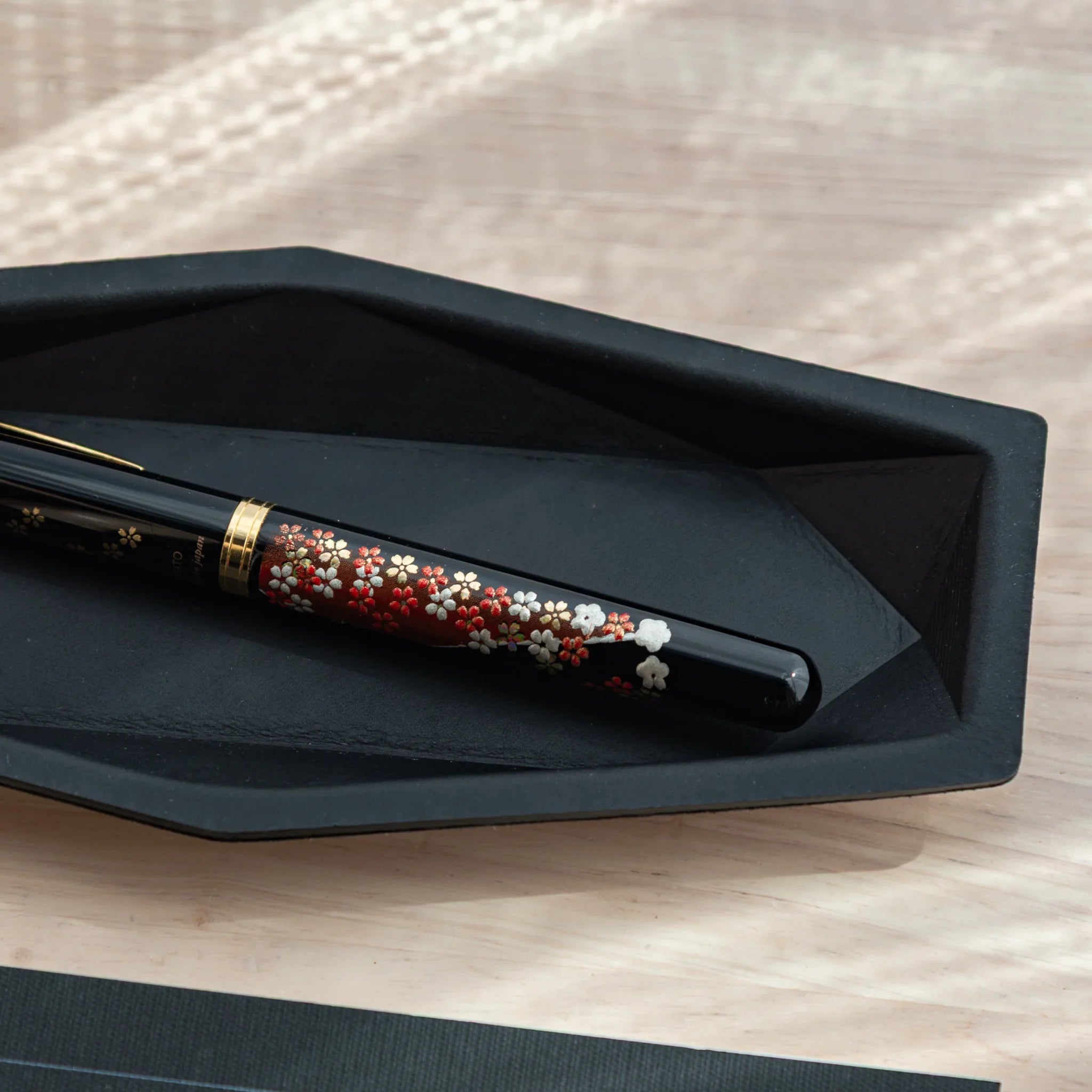 Side view accentuating the slim depth profile and minimalist design approach of the genuine leather pen storage tray