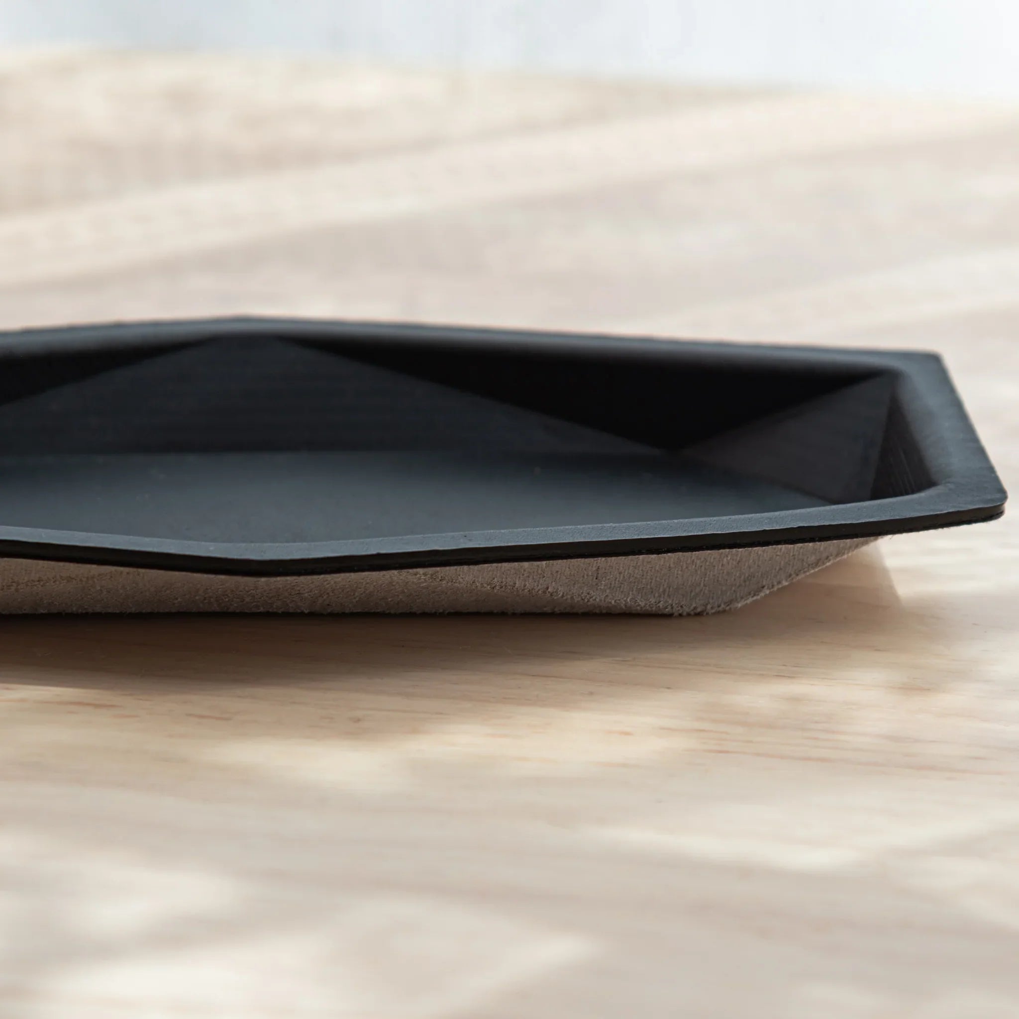 Side view of Japanese Pen Tray in black leather with black suede bottom.