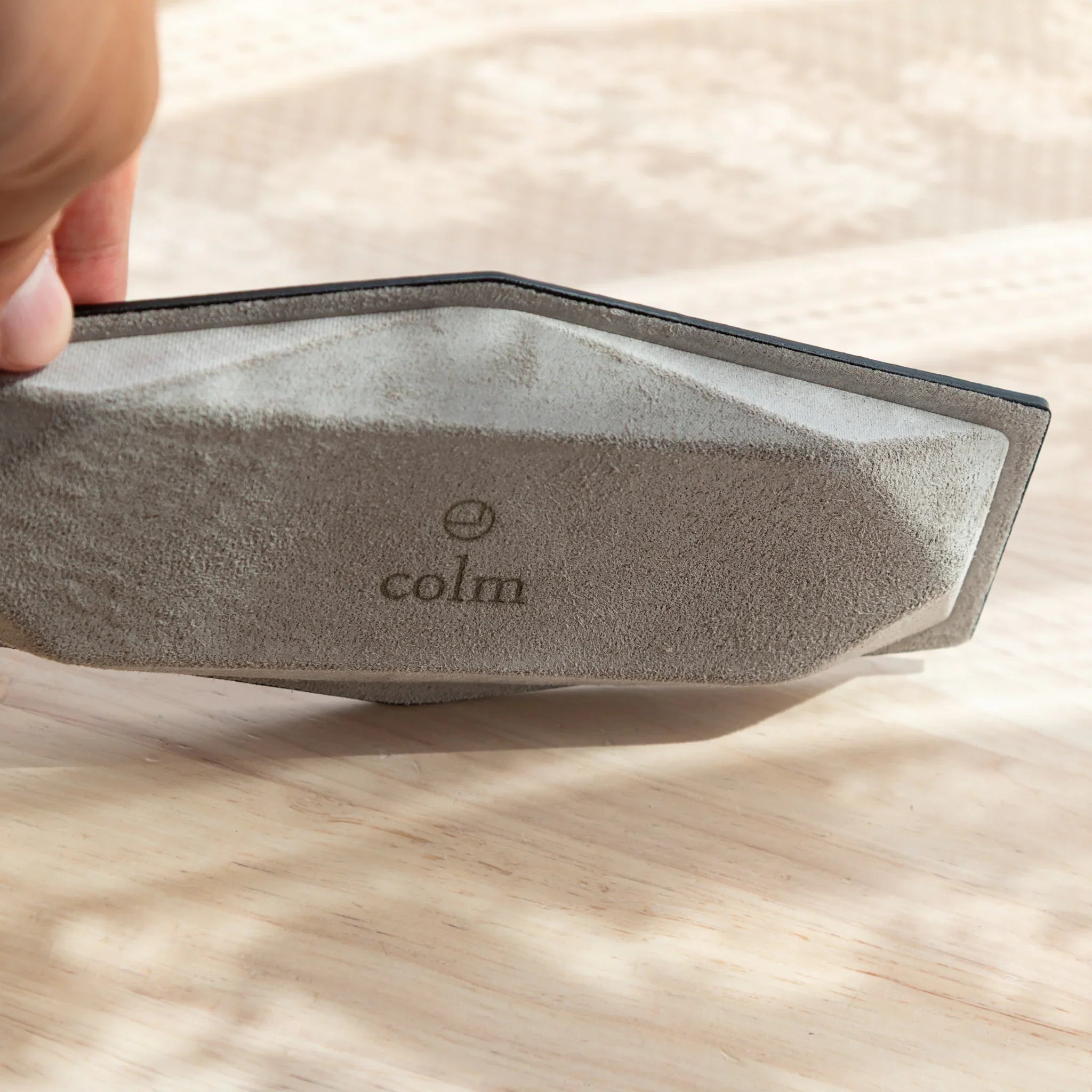 End-on perspective view showing the interior depth and distinctive hexagonal opening of the slim leather pen holder