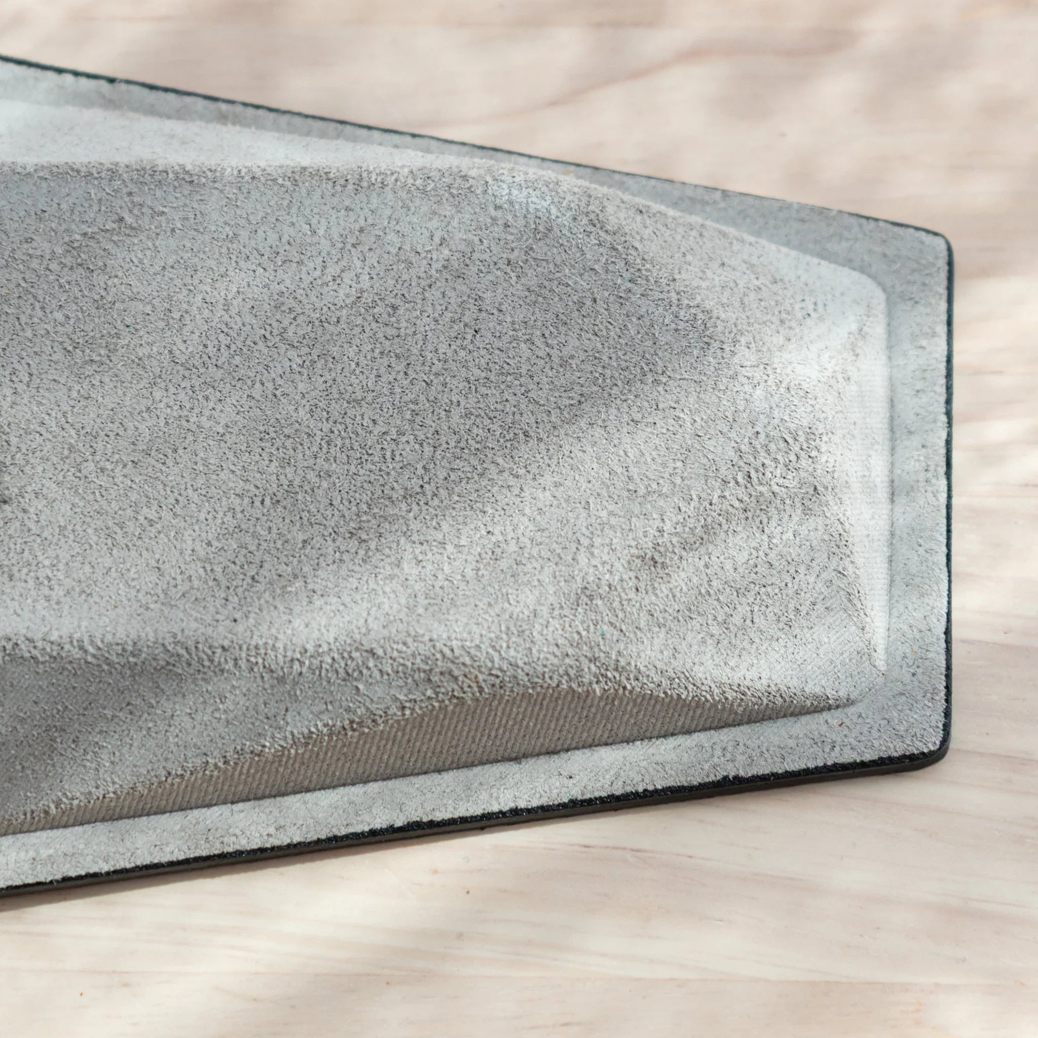 Slightly angled overhead view showing optimal pen placement area and empty storage zones within leather compartment