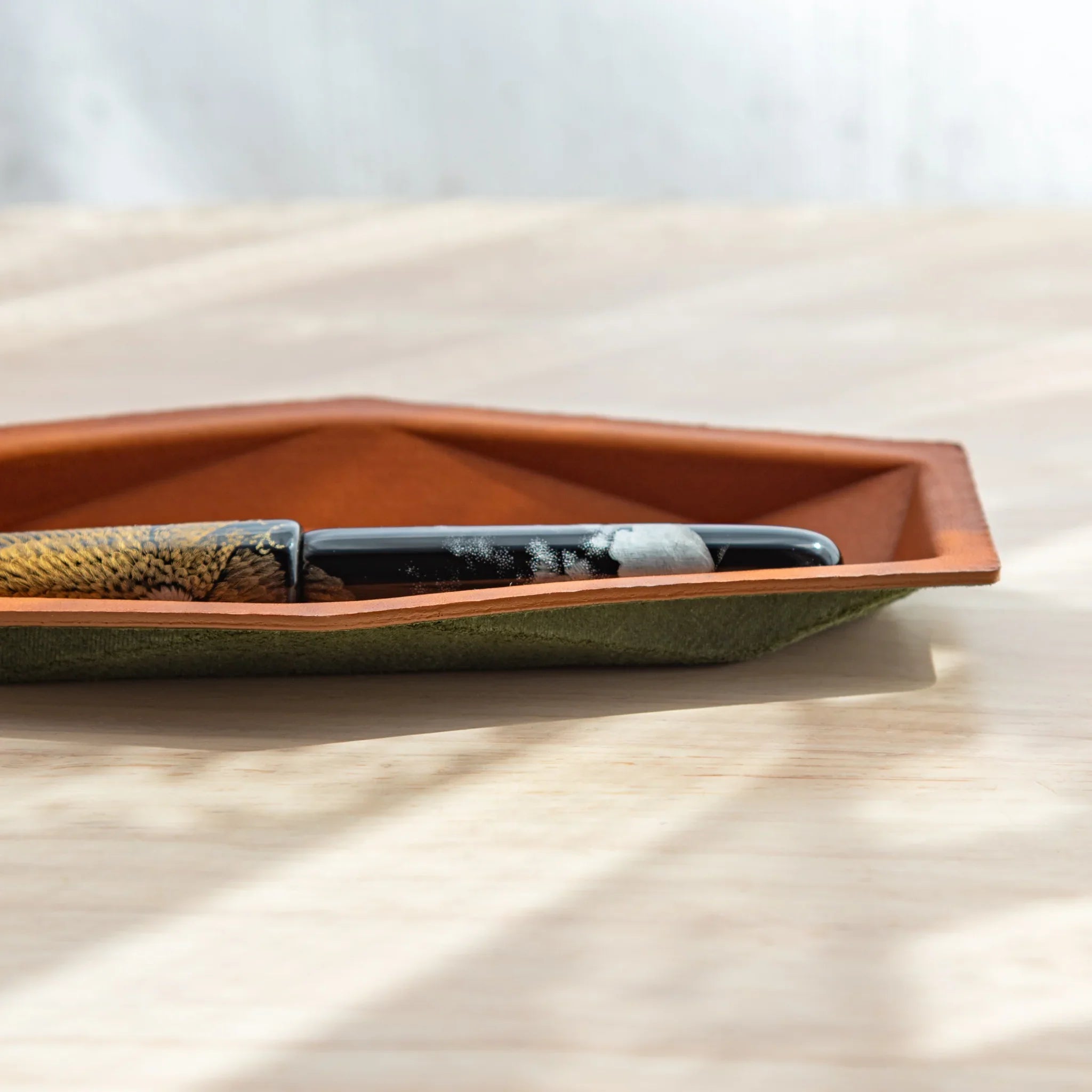 Close-up detail view capturing the saddle-stitching along the edges and structural design elements of pen holder