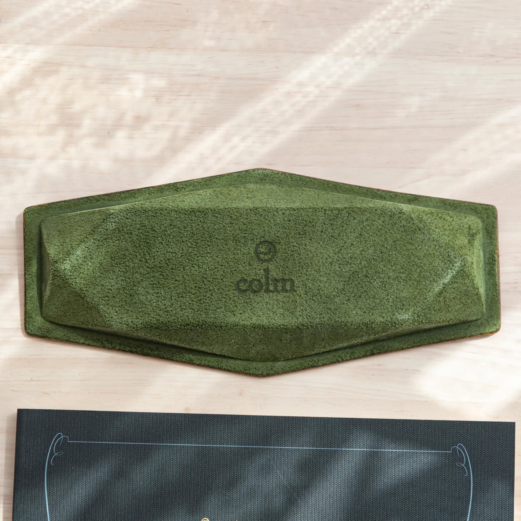 Overhead view of empty pen tray precisely centered in frame showing hexagonal shape and interior suede lining design