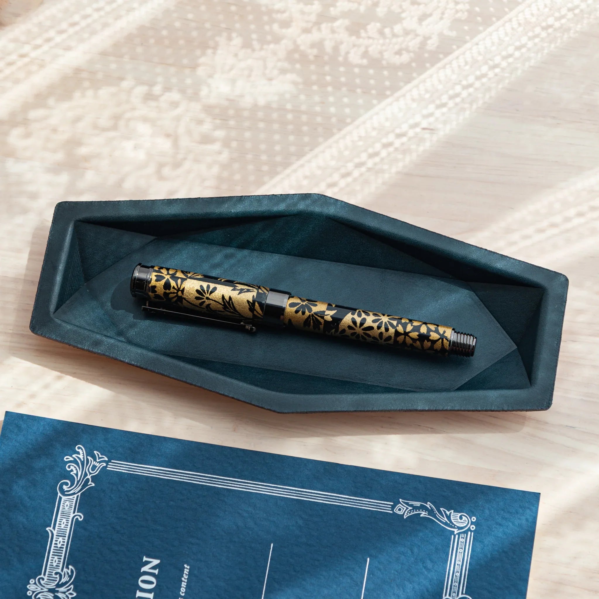Overhead view with subtle angle showing optimal pen placement area and soft brown suede interior of leather tray