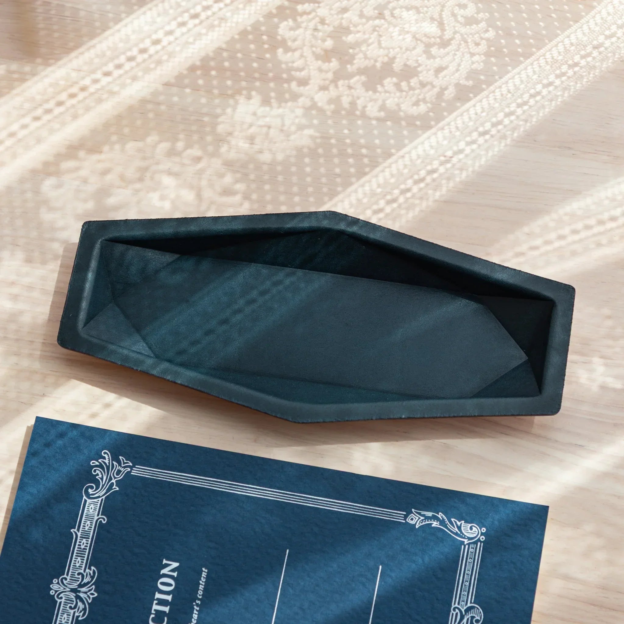 Japanese Pen Tray in Teal-Blue suede, hexagonal slim shape, displayed on a wooden desk.